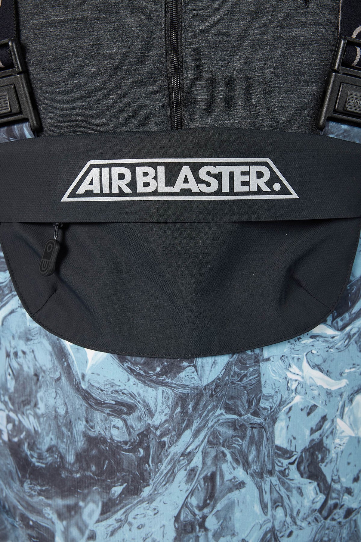 Black backpack with 'AIR BLASTER' logo on a textured gray background