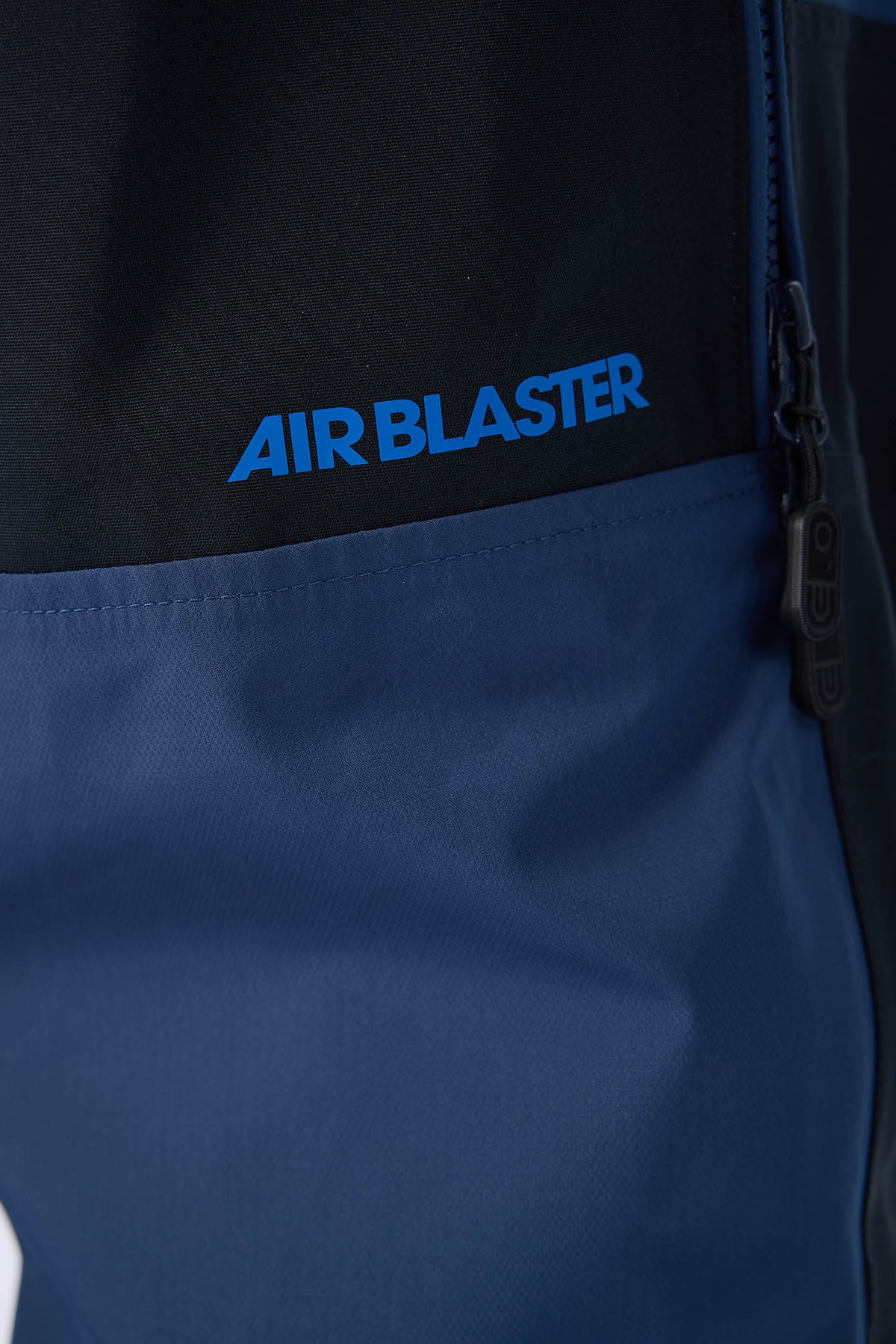 Close-up of a blue jacket with 'AIR BLASTER' branding on the chest.