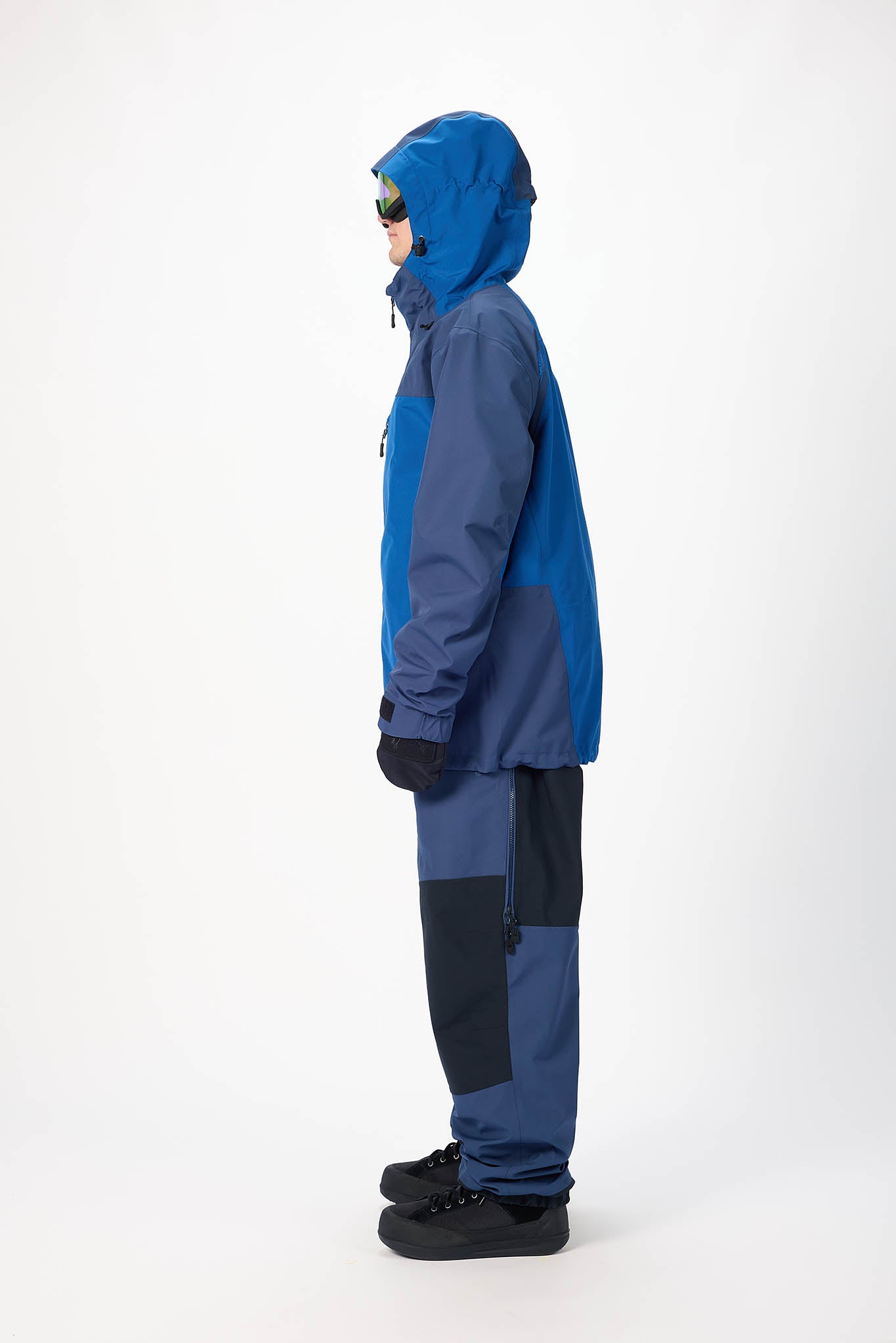 Person wearing a blue snowsuit on a white background