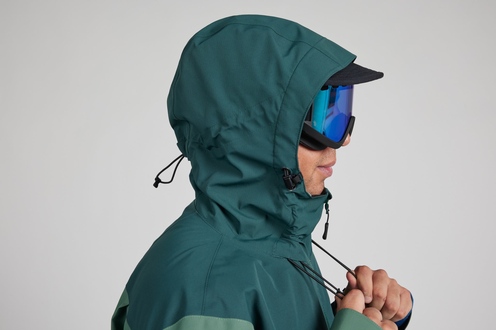 drawl cord being pulled on jacket with a white background