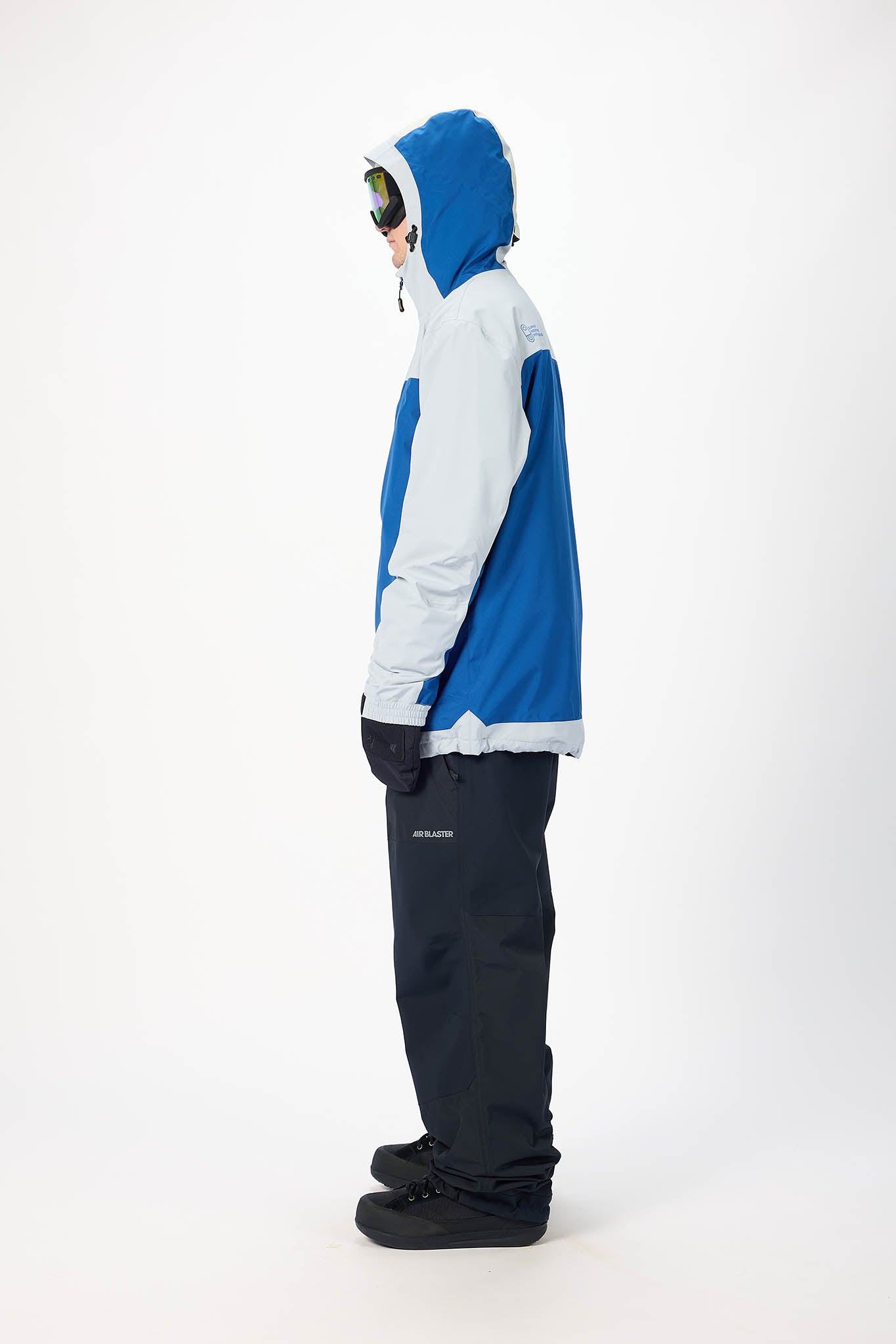 Person wearing a blue and white jacket with black pants on a white background