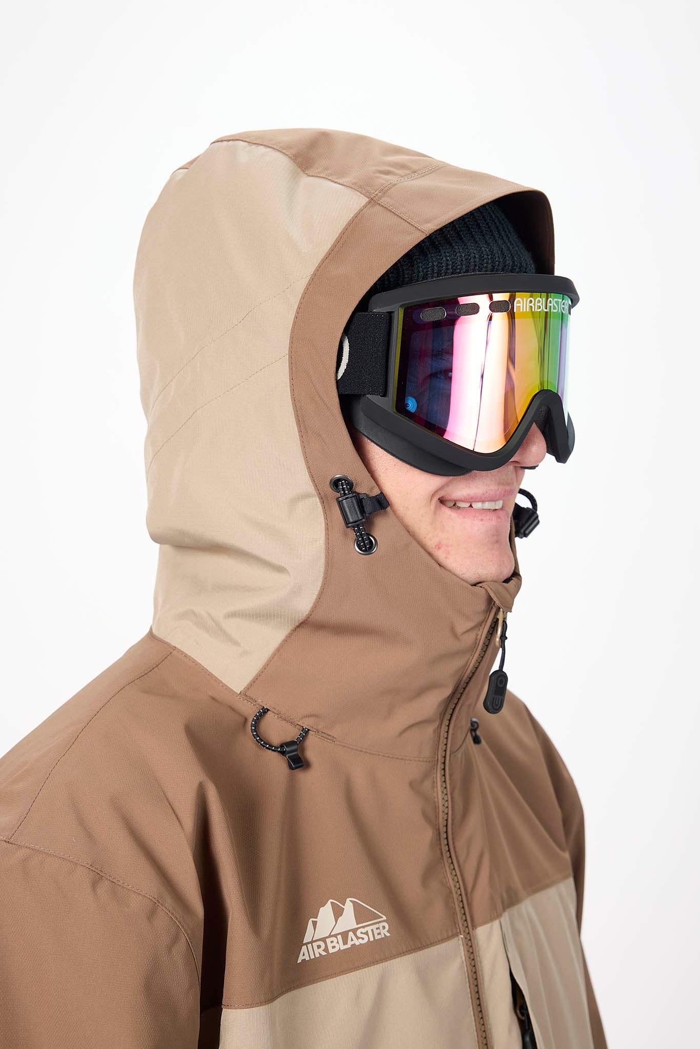 close up of model wearing goggles beige jacket