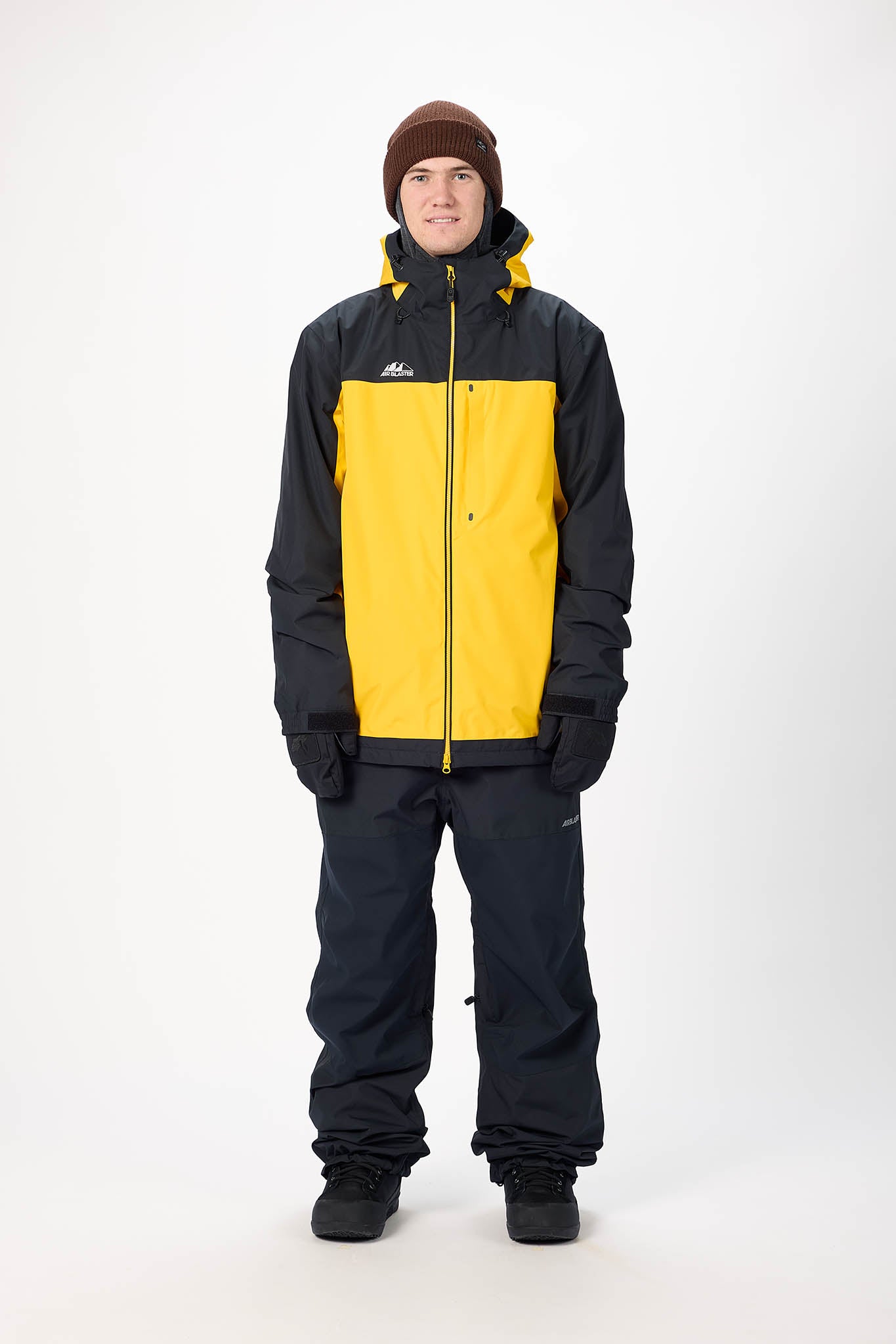 Person wearing a black and yellow snowsuit on a white background