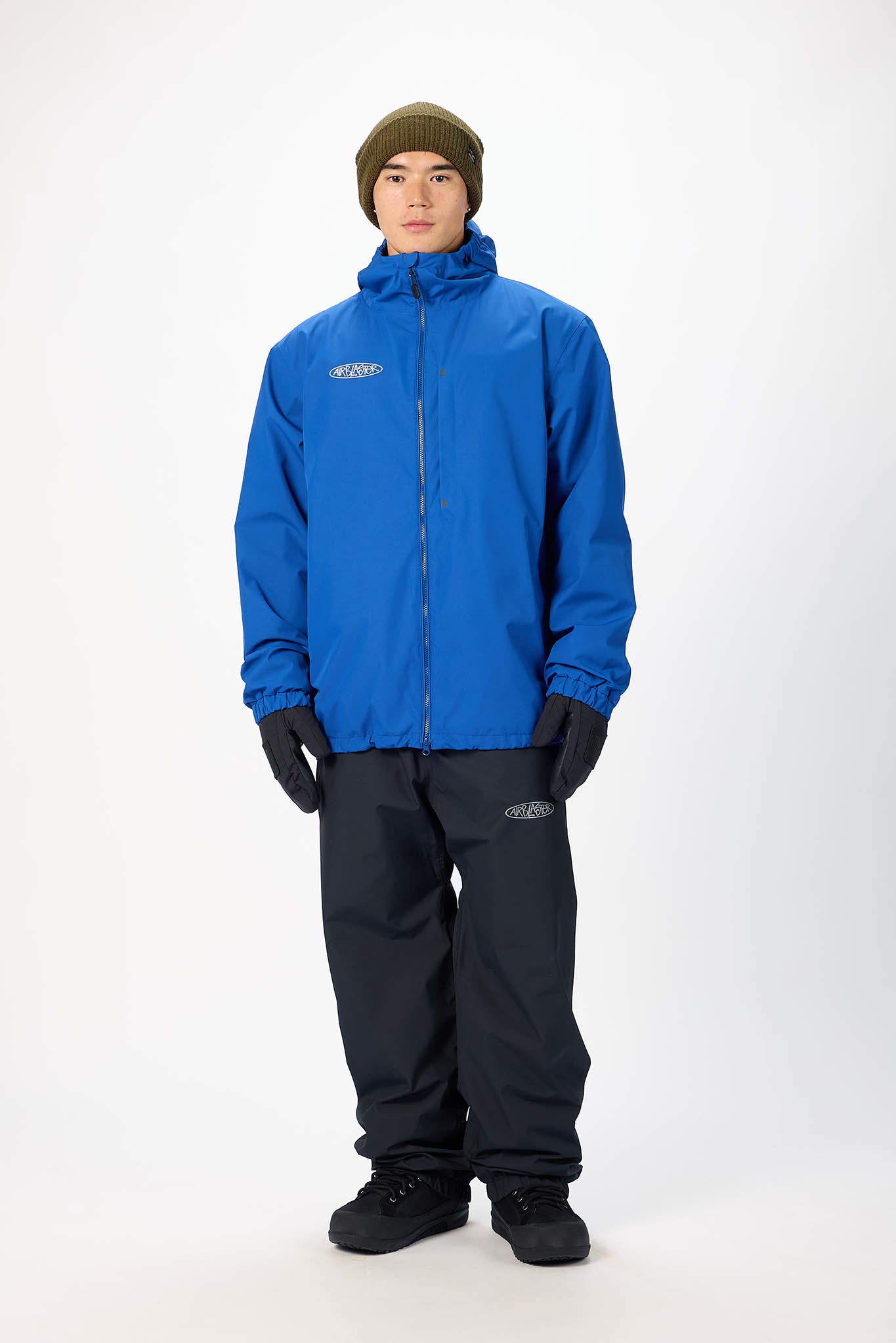 Person wearing a blue raincoat and black pants on a white background