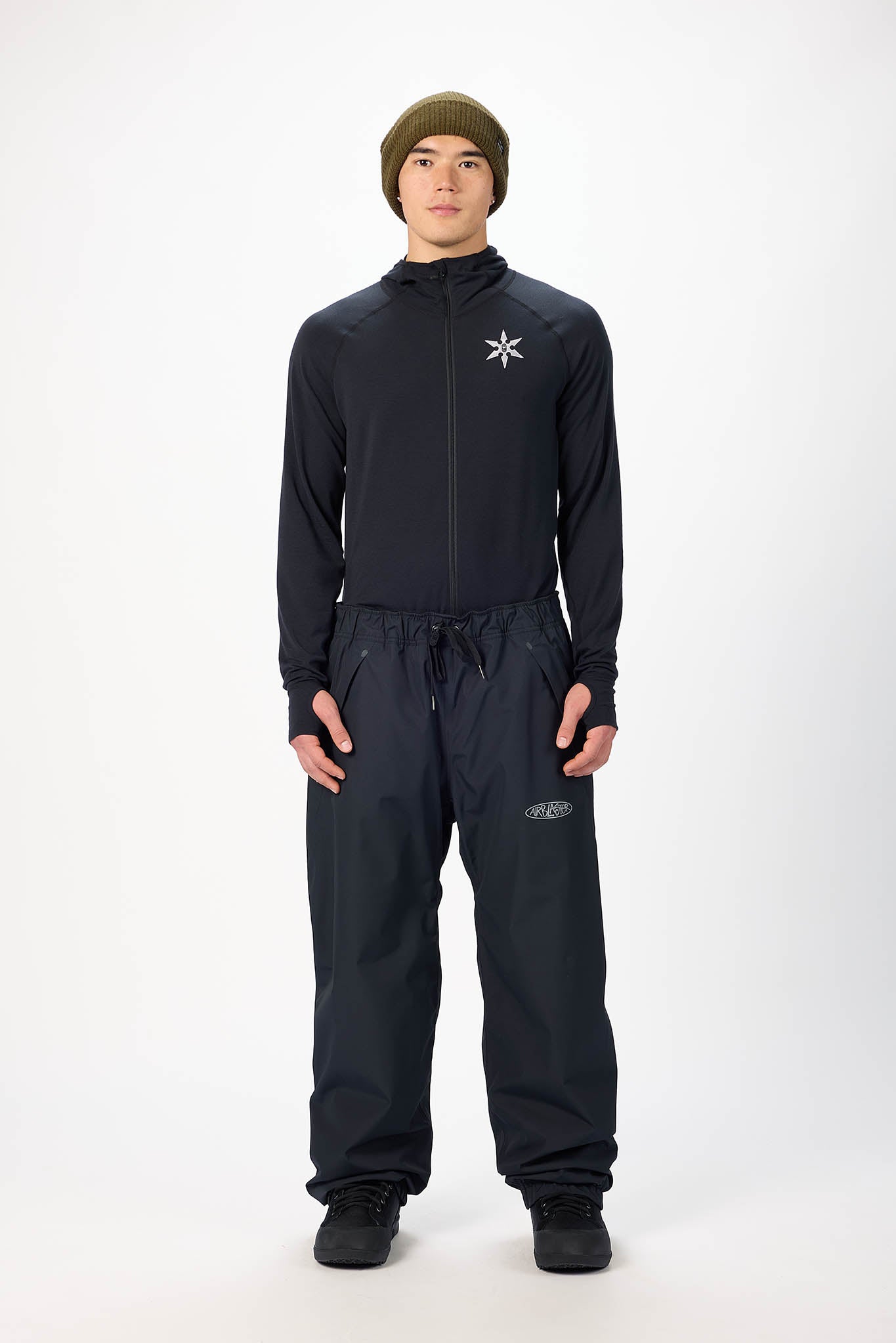Person wearing a black outfit with a logo on a white background