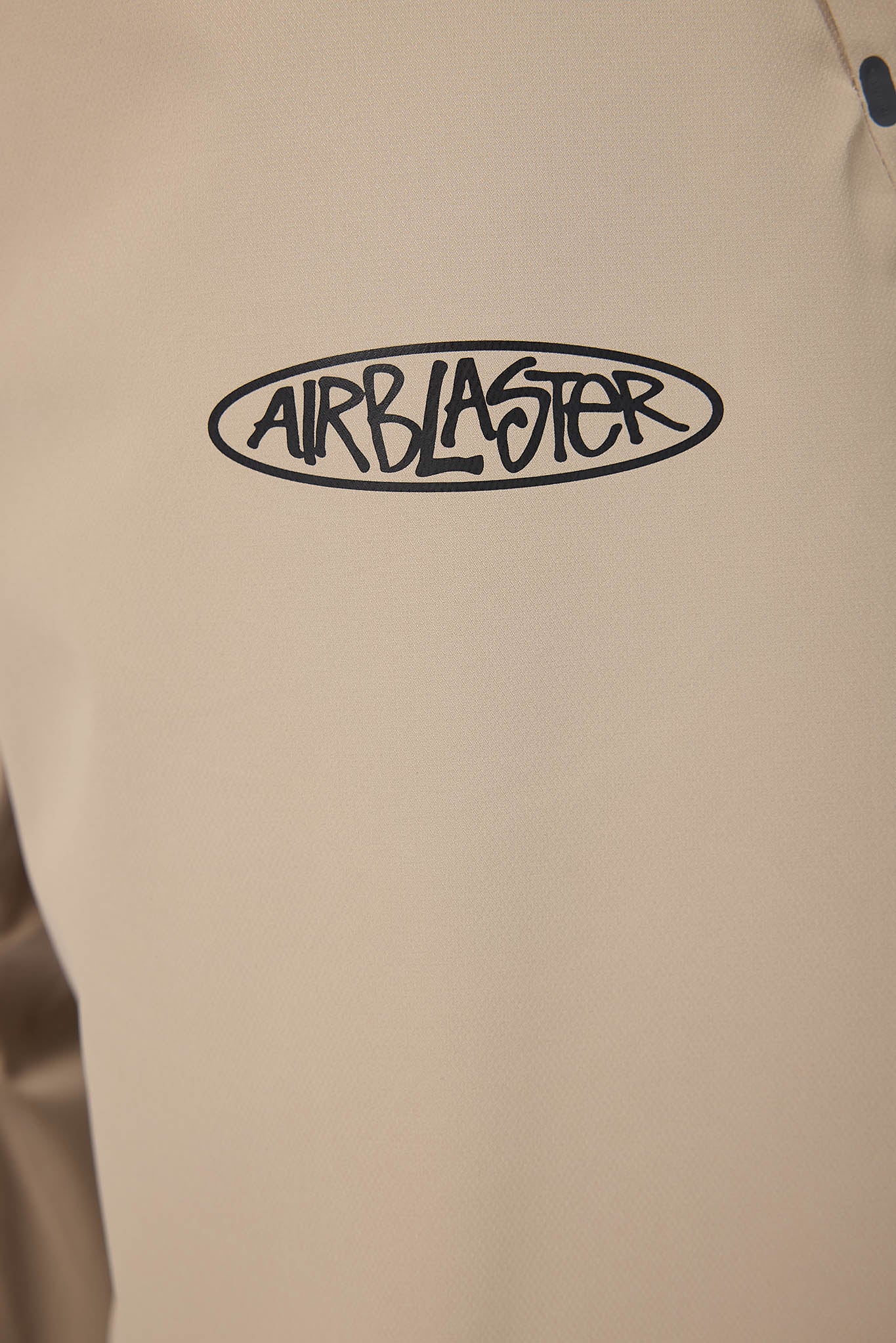 Beige jacket with 'Airblaster' logo on a beige background