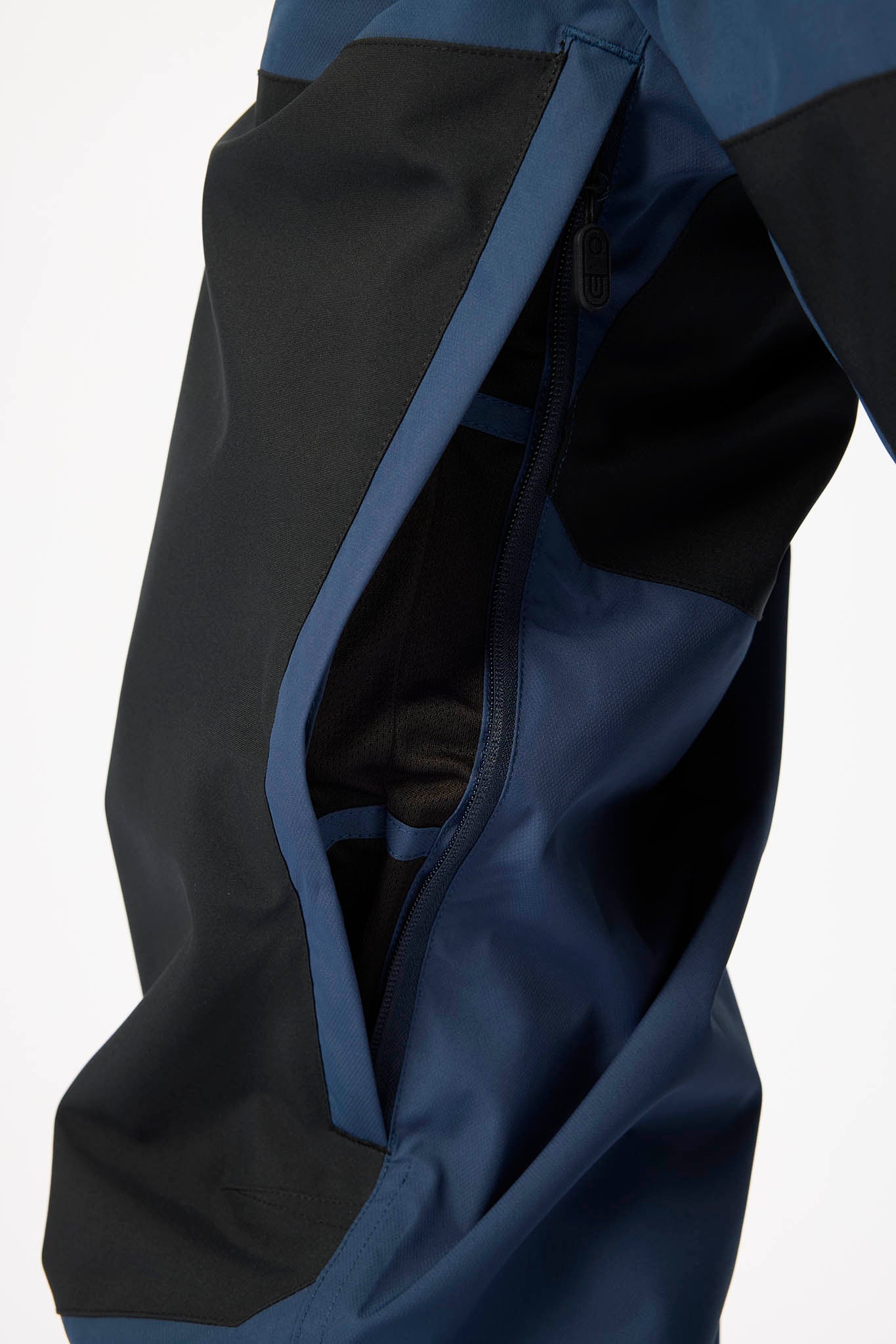 Close-up of a blue and black jacket with a hood on a white background