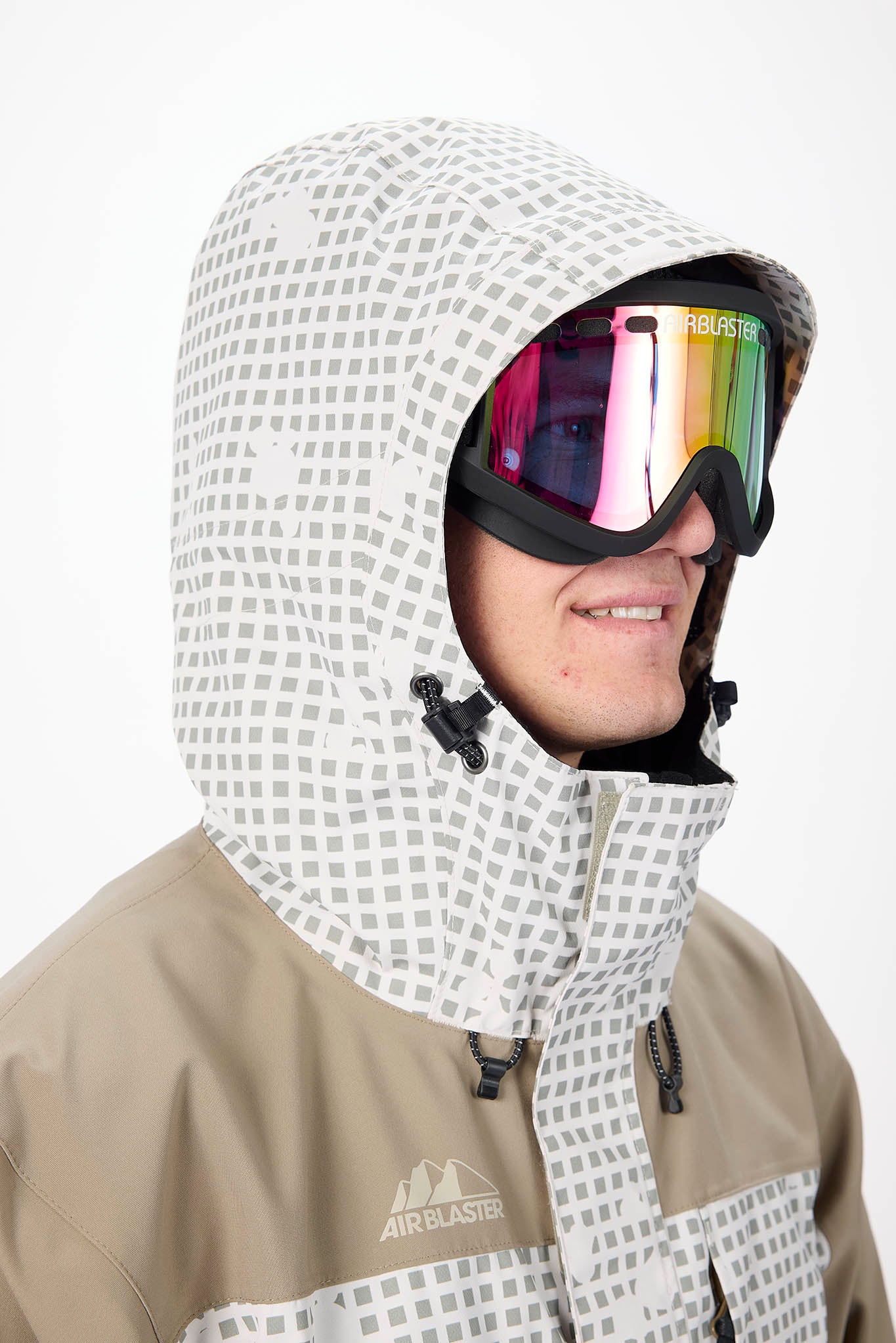 Person wearing a patterned hood and goggles with a visible brand logo on a white background