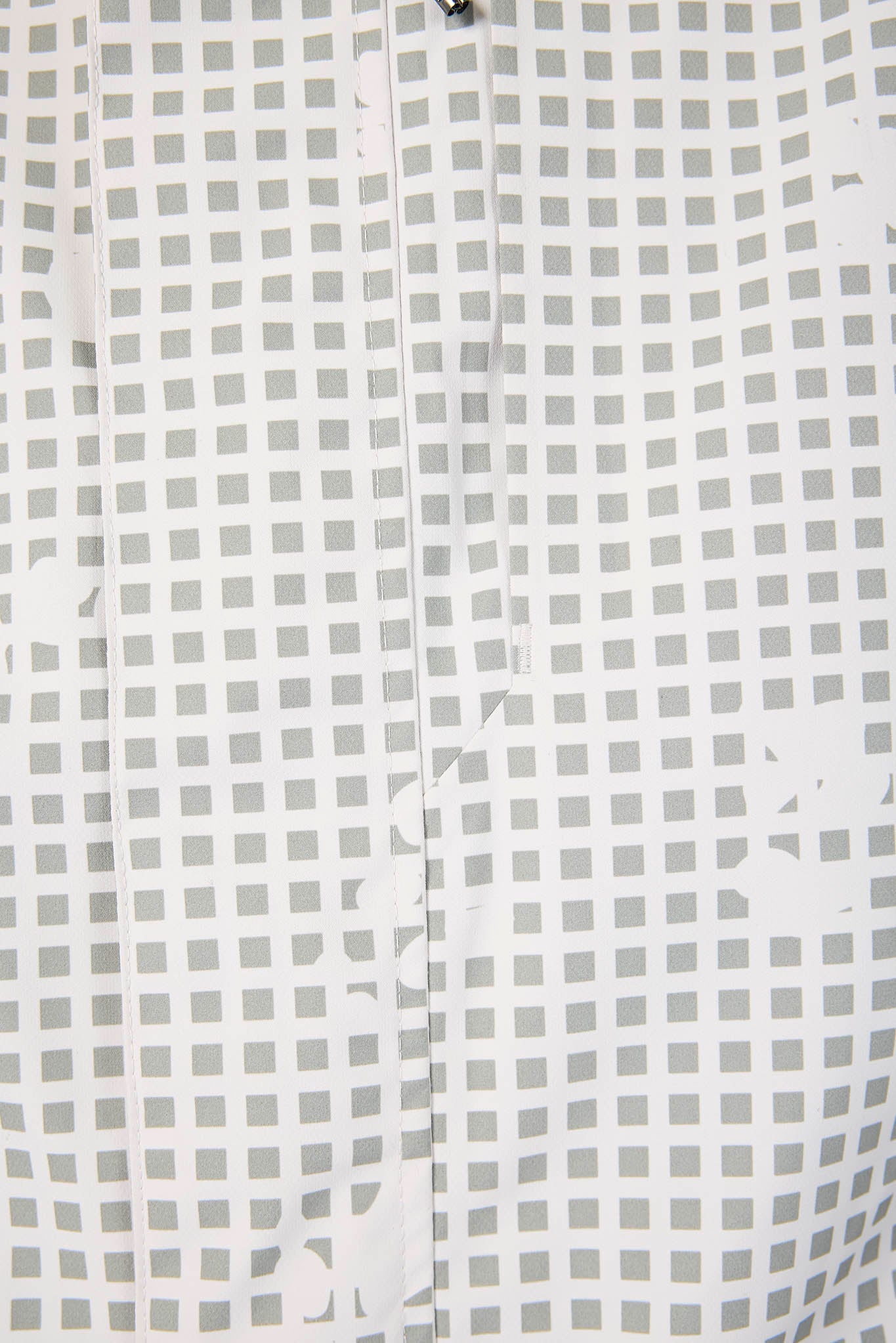 Close-up of a white shirt with a subtle grid pattern
