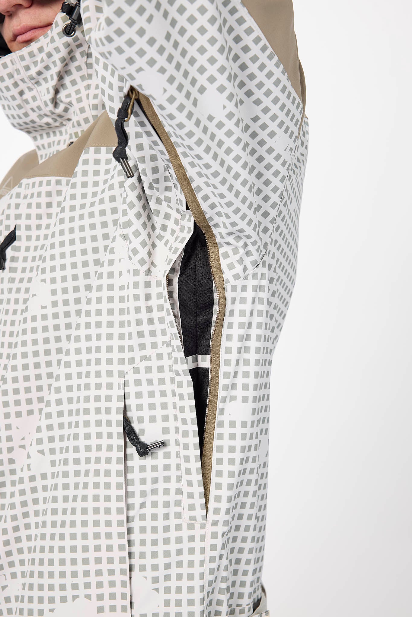 Close-up of a person wearing a checkered jacket with a white background