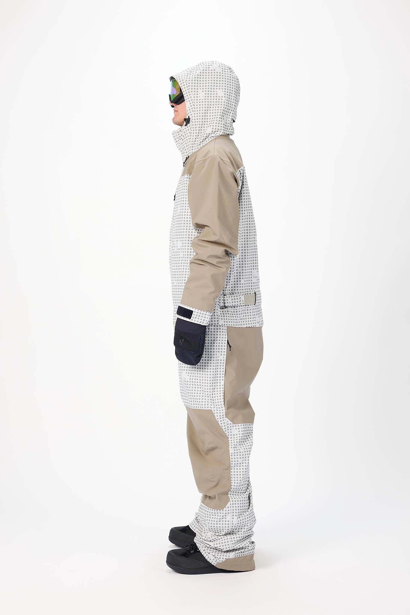 Person wearing a checkered snowsuit with a hood on a white background