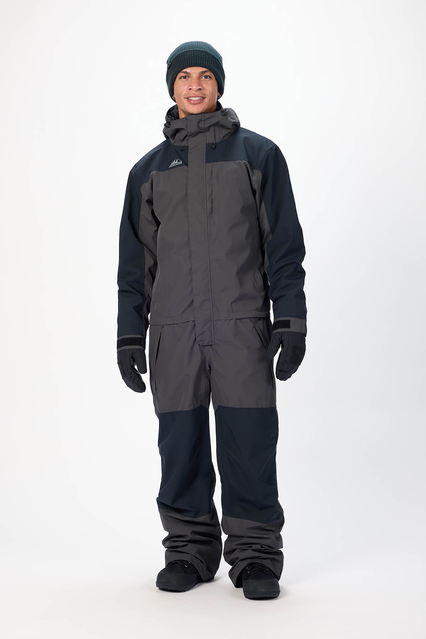 Person wearing a black and gray snowsuit on a white background