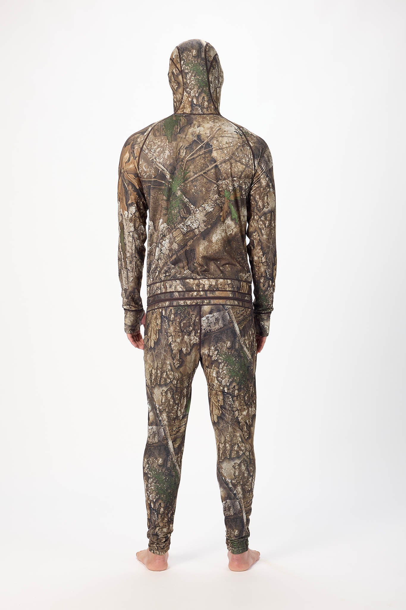 viewed from behind man wearing a realtree camouflage onesie with a hooded zip-up jacket and jogger pants, standing against a plain white studio background.
