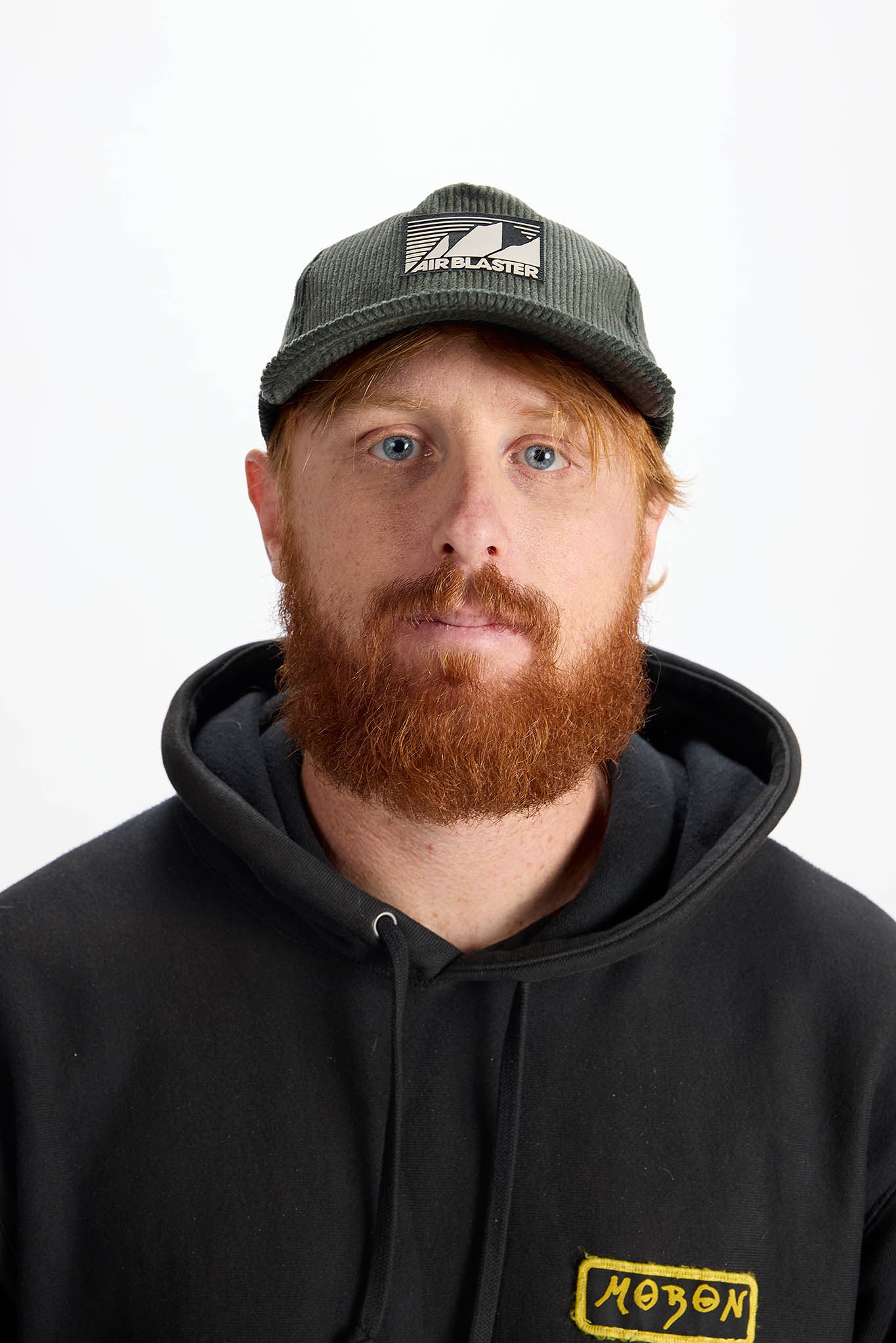 model wearing a green baseball cap with white background