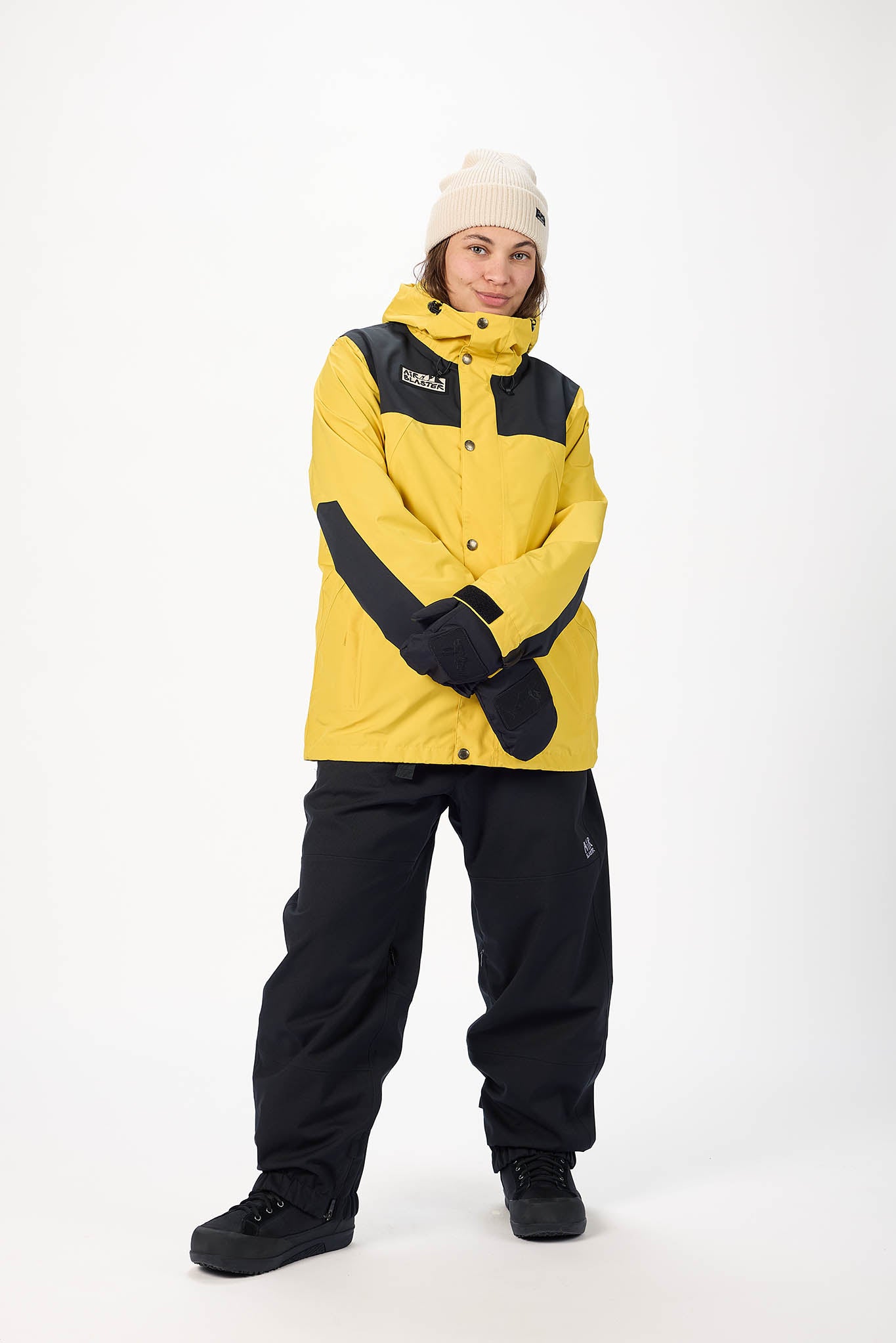 Person wearing a yellow and black snowsuit on a white background