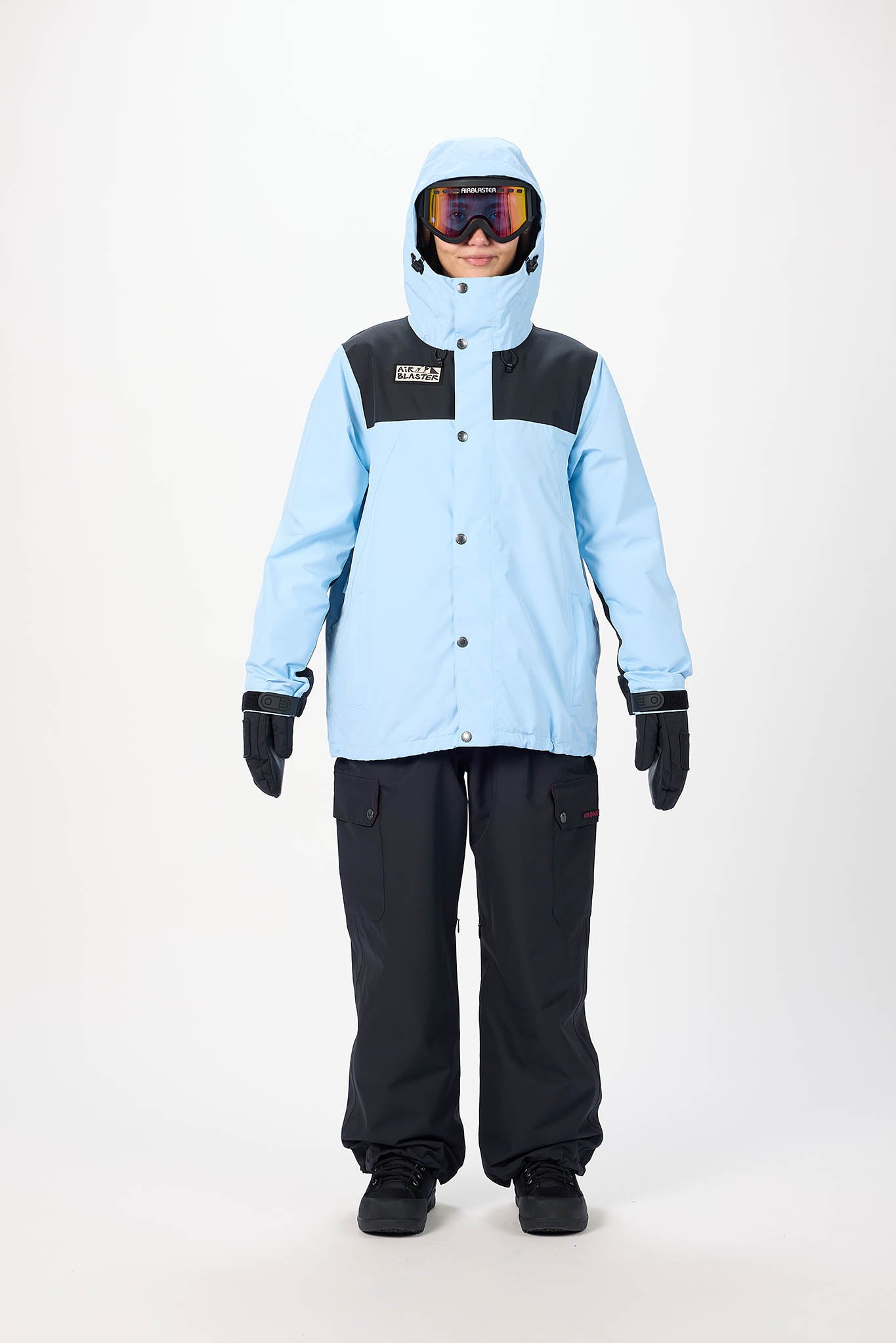 Person wearing a light blue and black snow jacket with matching pants on a white background