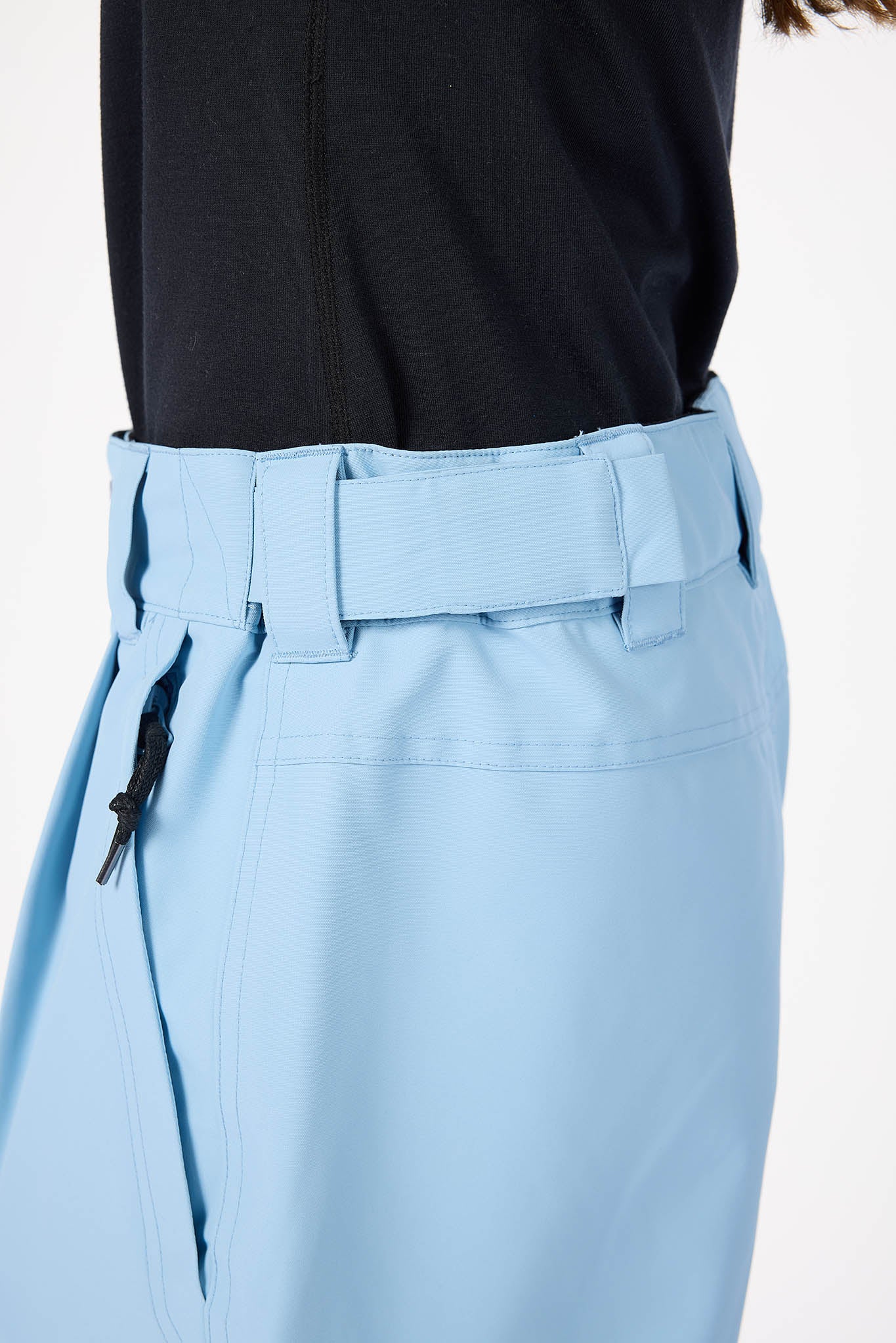 Light blue pants with a belt worn by a person, on a white background