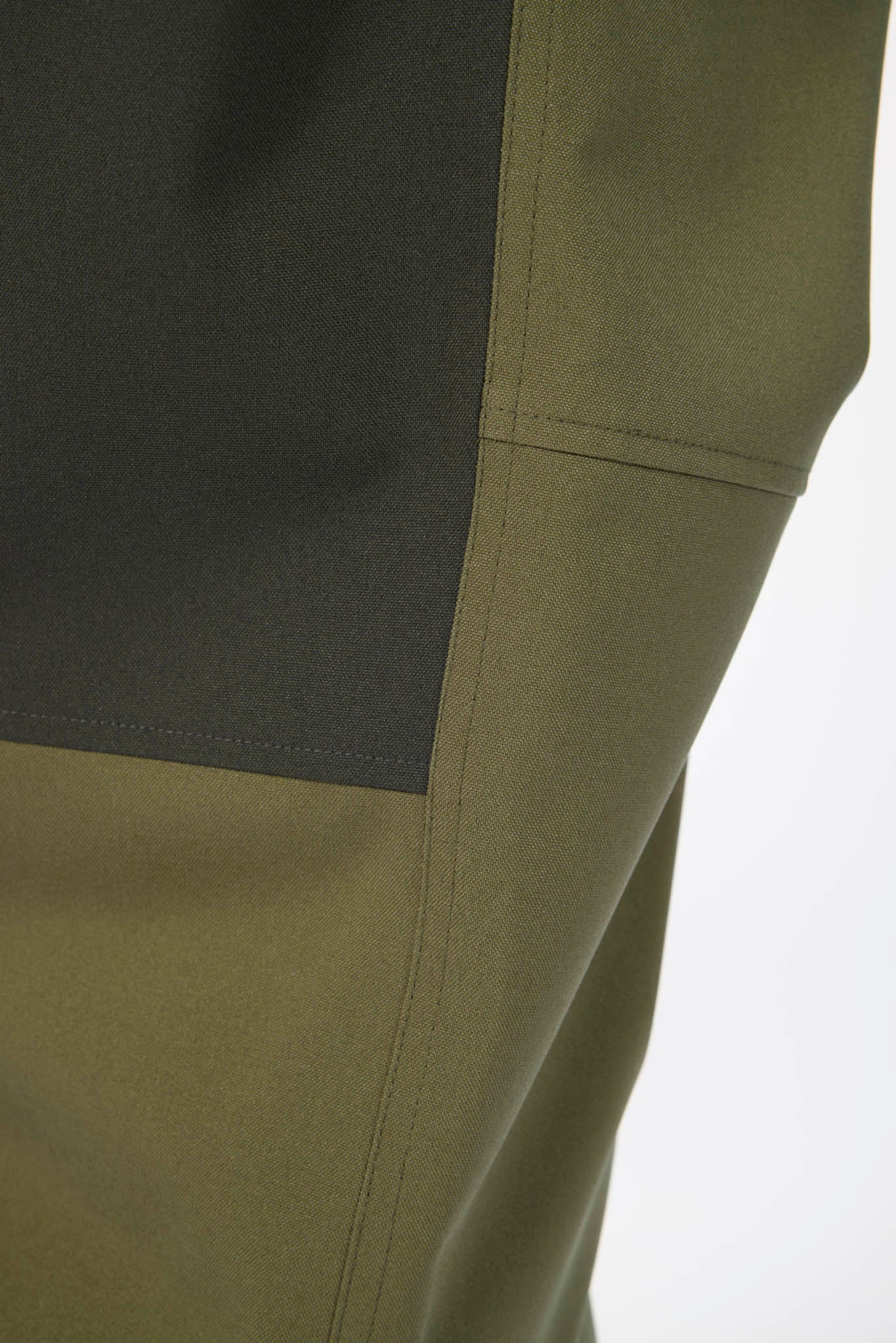 Close-up of green pants with a white background