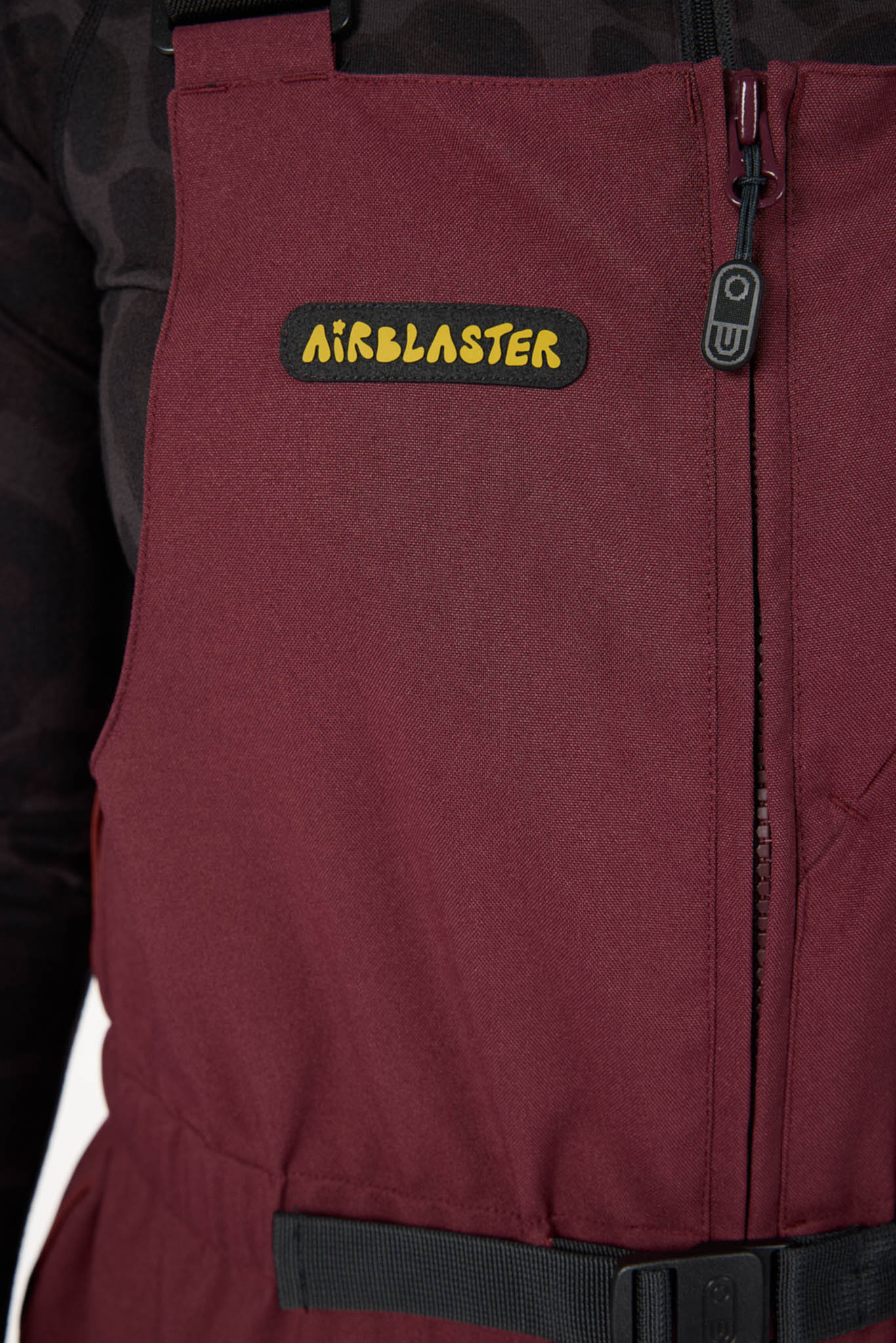 Maroon jacket with Airblaster logo on a dark background