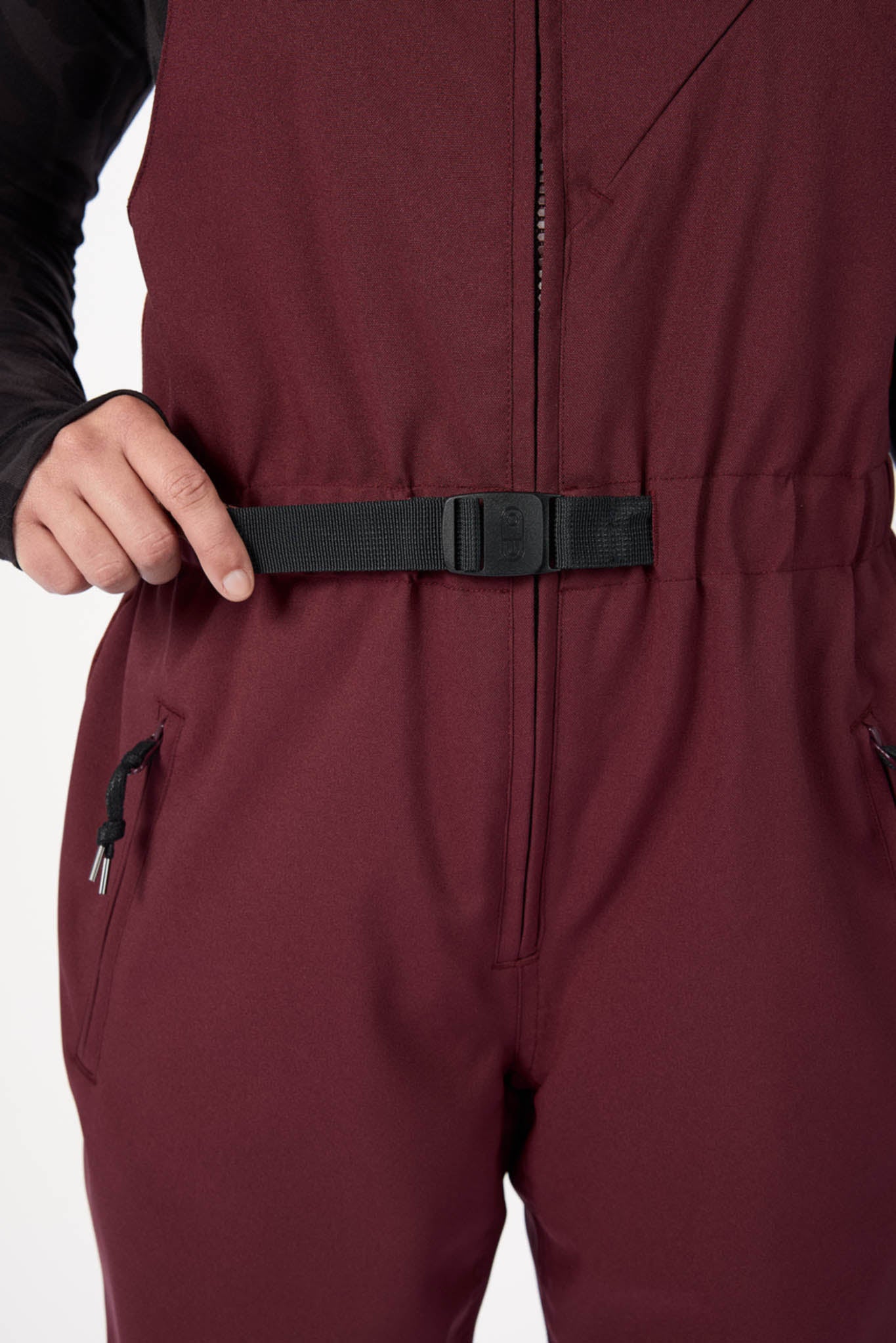Maroon jumpsuit with a black belt on a white background