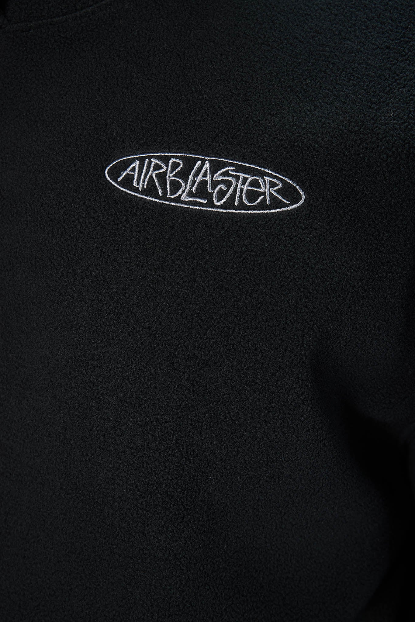 close upon black clothing, highlighting AIR blaster oval