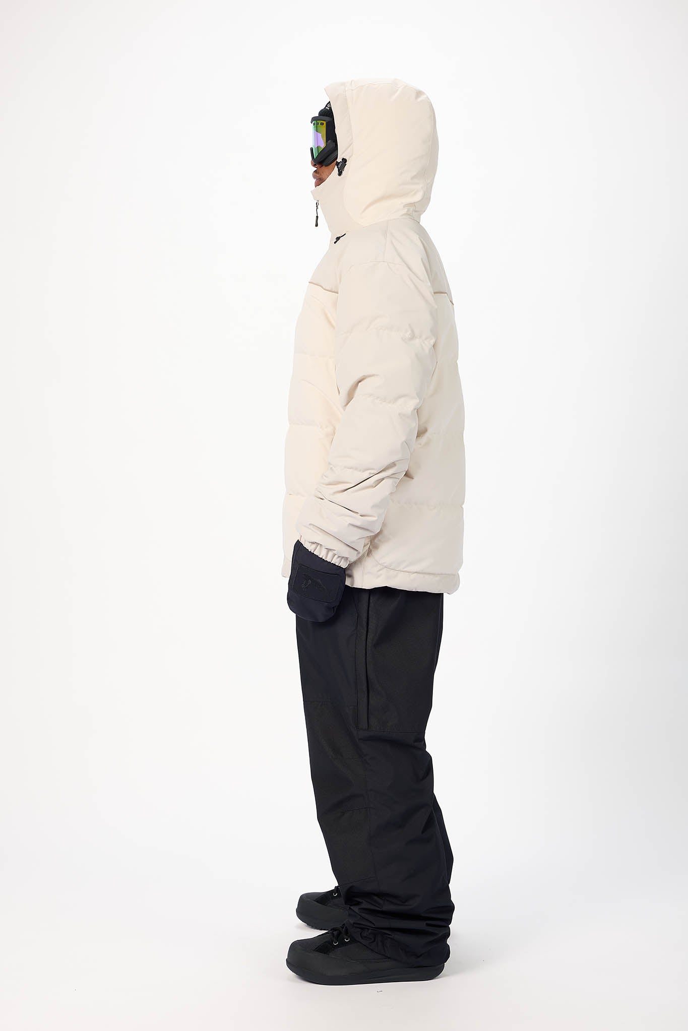 Person wearing a white puffer jacket and black pants on a white background