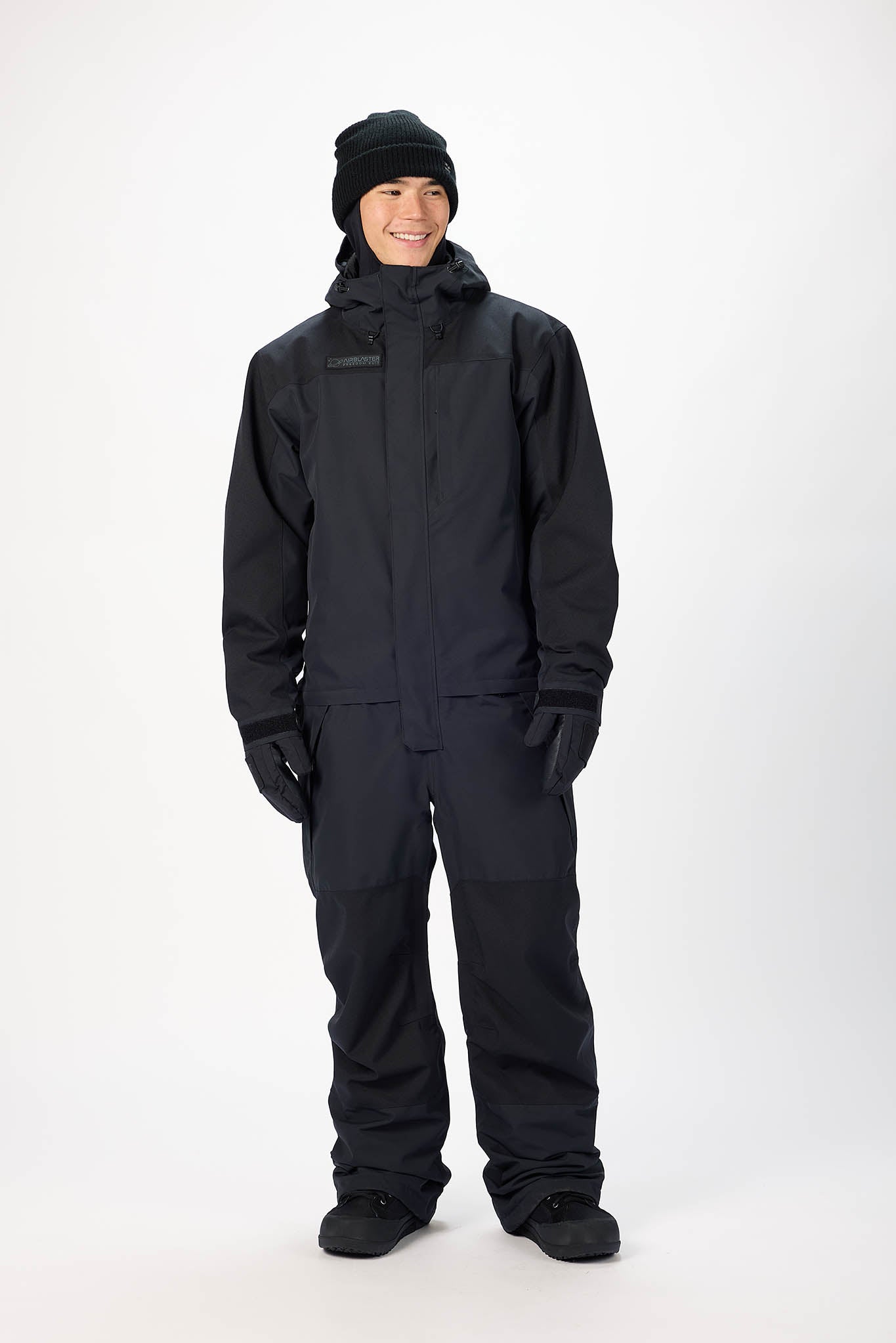 Person wearing a black snowsuit on a white background