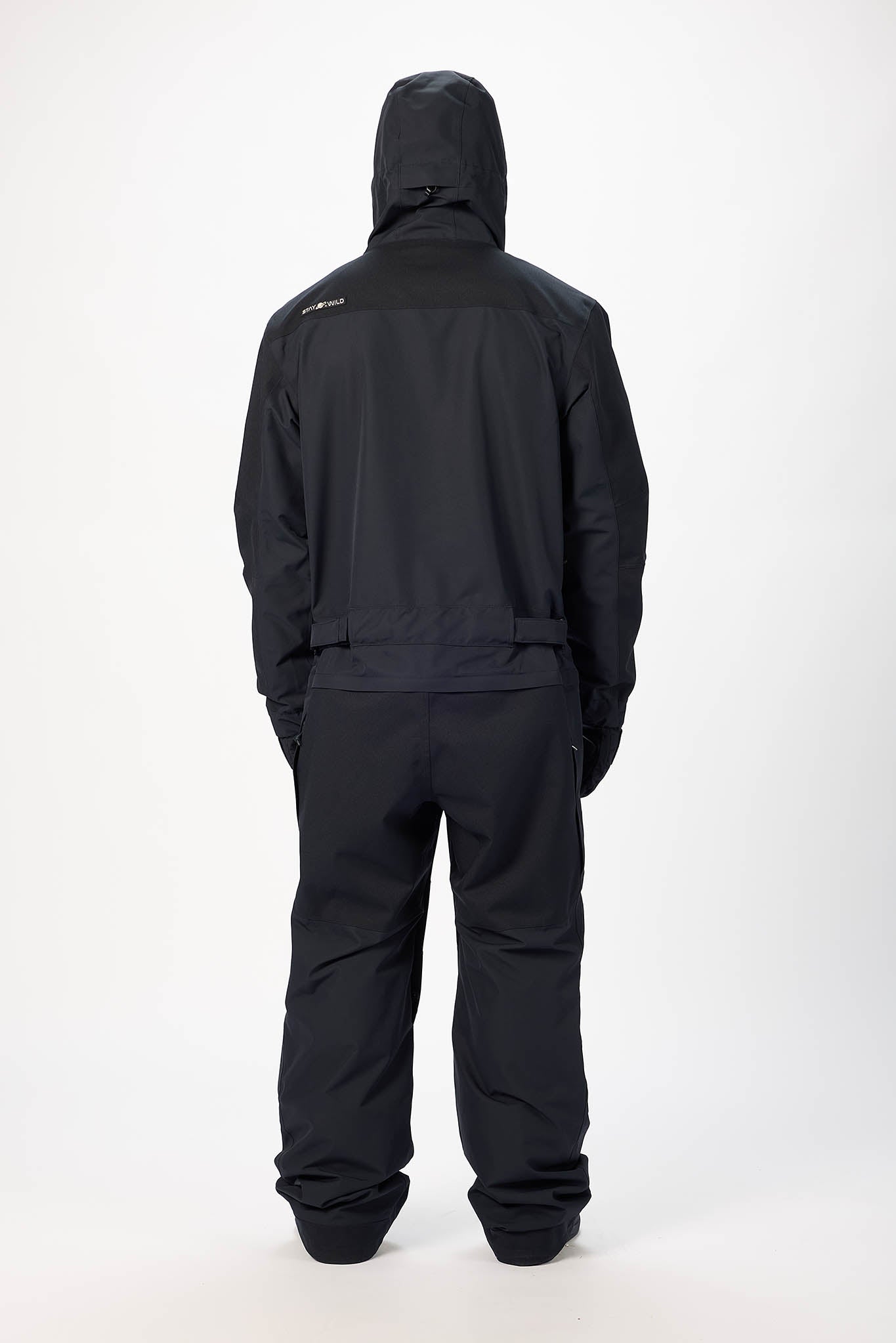 Person wearing a black raincoat and pants on a white background