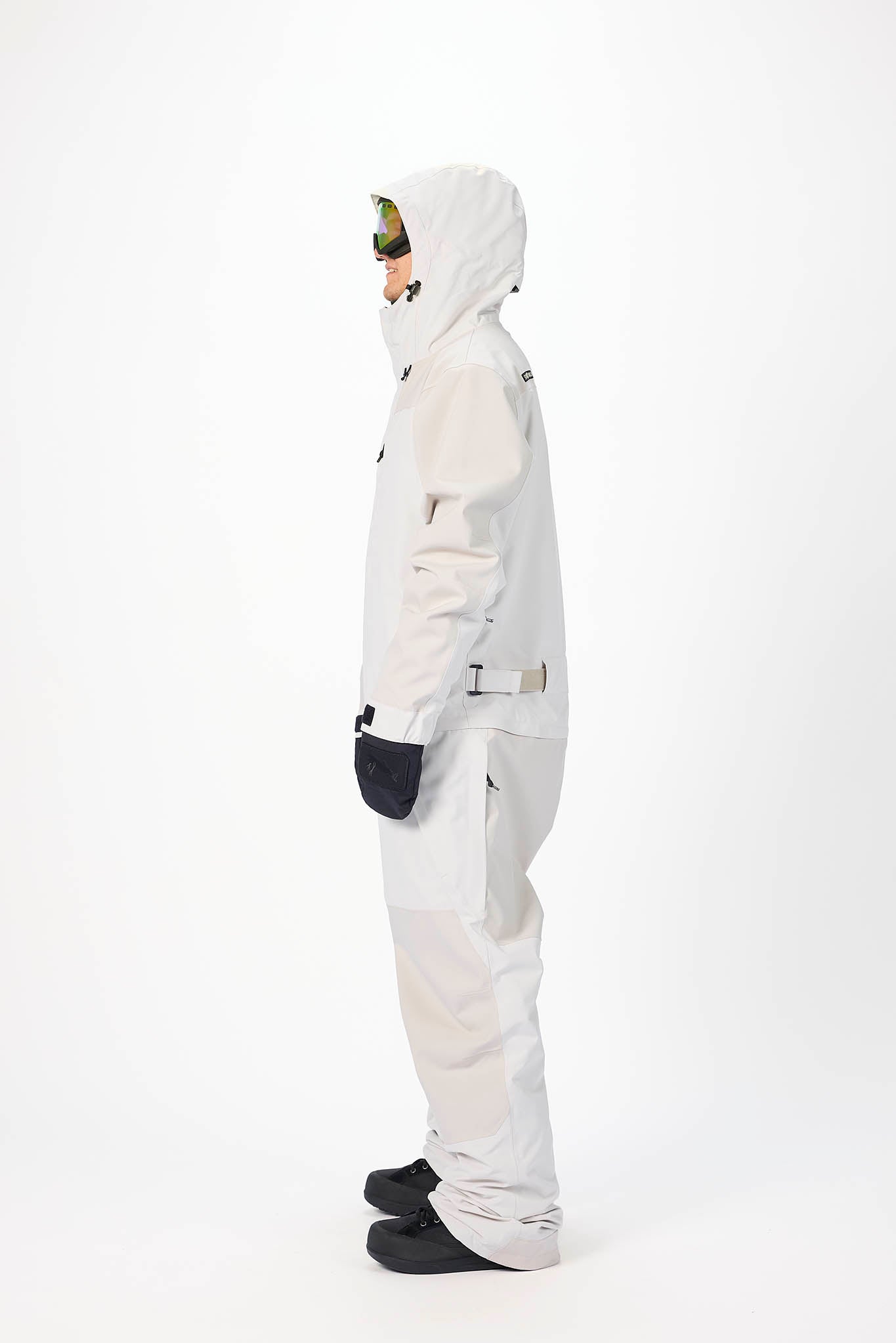 Person wearing a white snowsuit on a white background