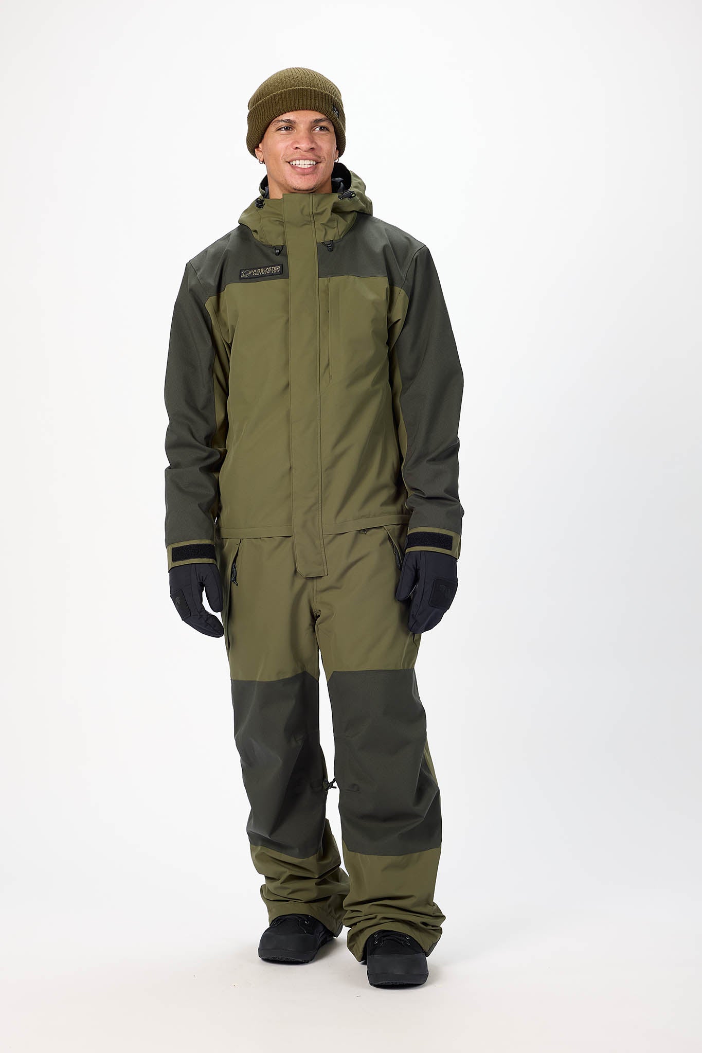Person wearing a green and gray snowmobile suit on a white background