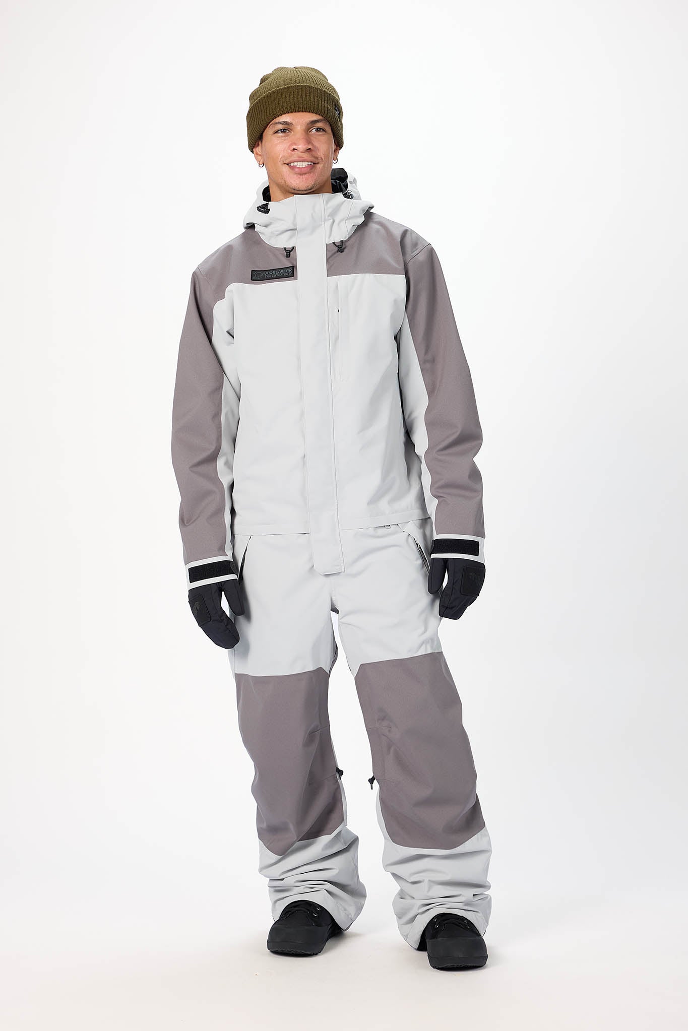 Person wearing a gray and white snowsuit on a white background