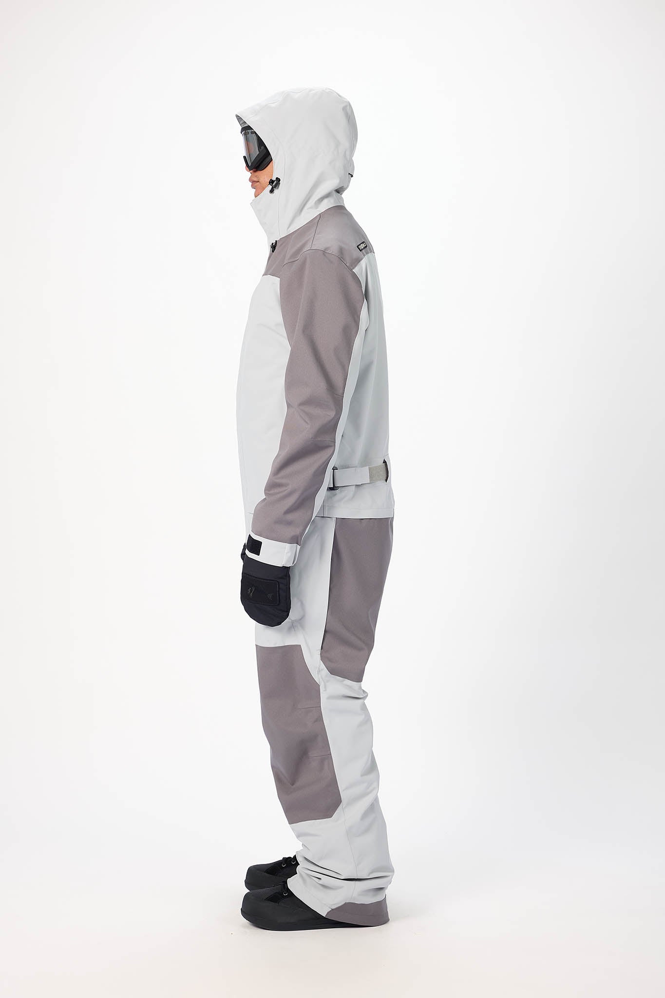 Person wearing a gray and white snowsuit on a white background