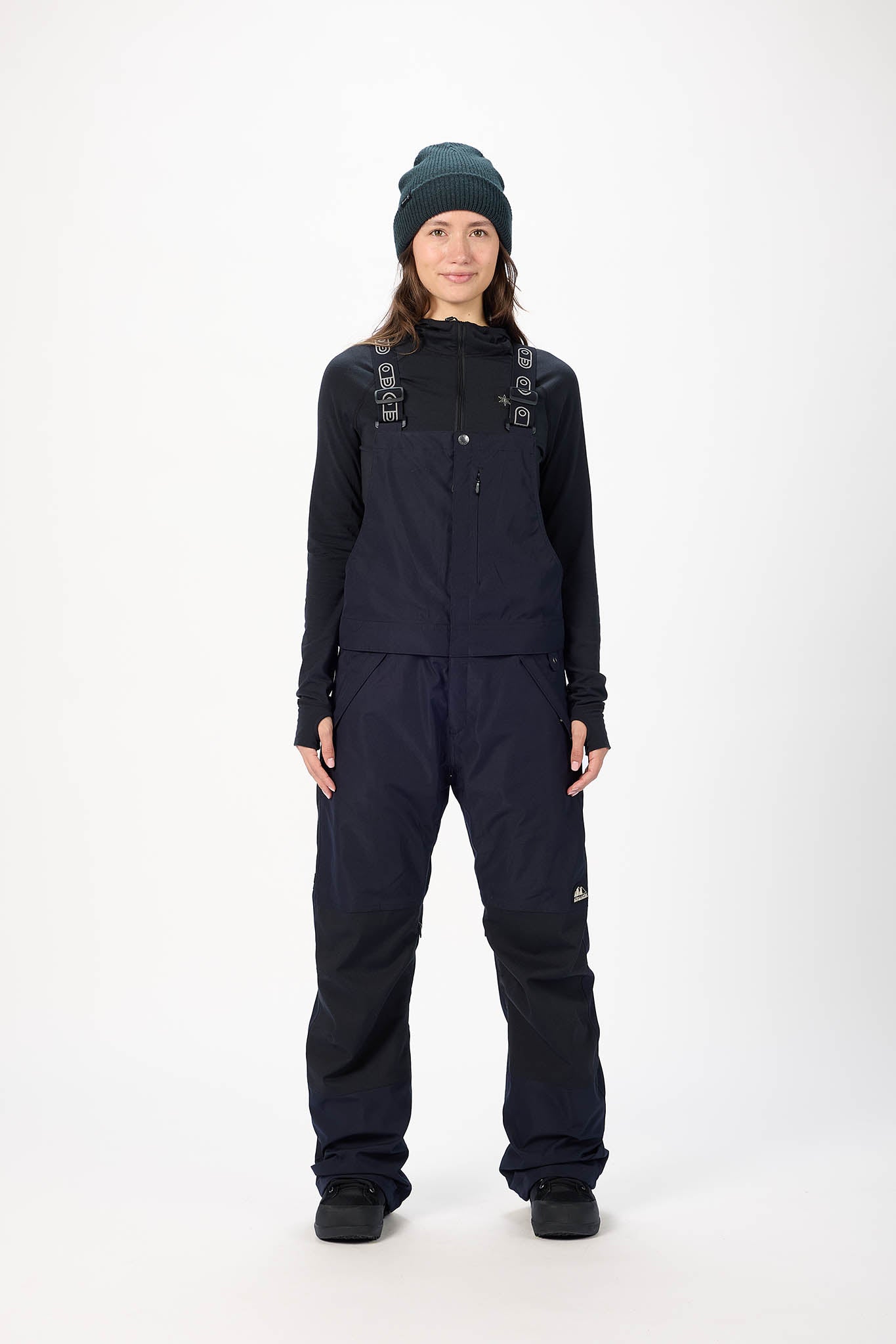 Person wearing a black snowsuit with a hood on a white background