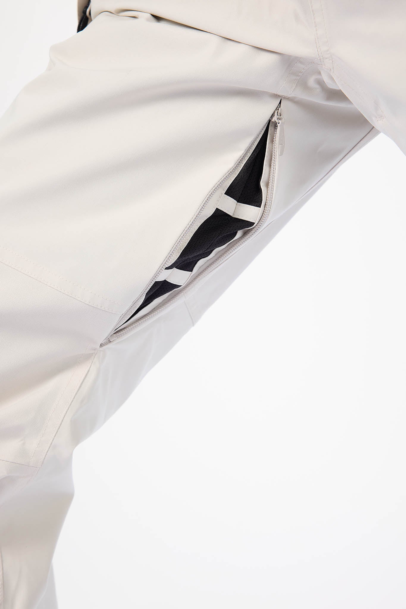 Close-up of a white suit with a pocket detail on a light gray background