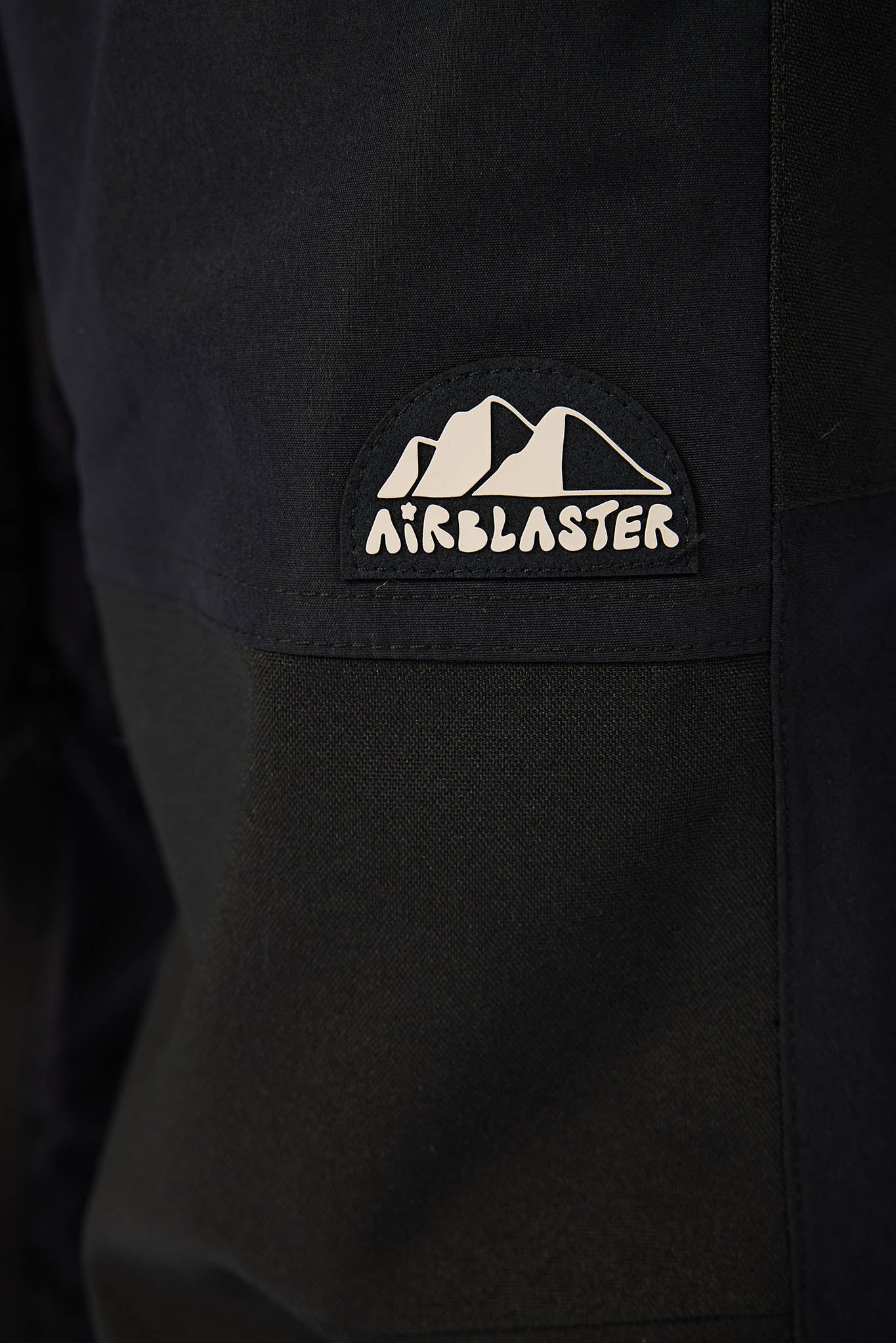 Black jacket with Airblaster logo on a dark background