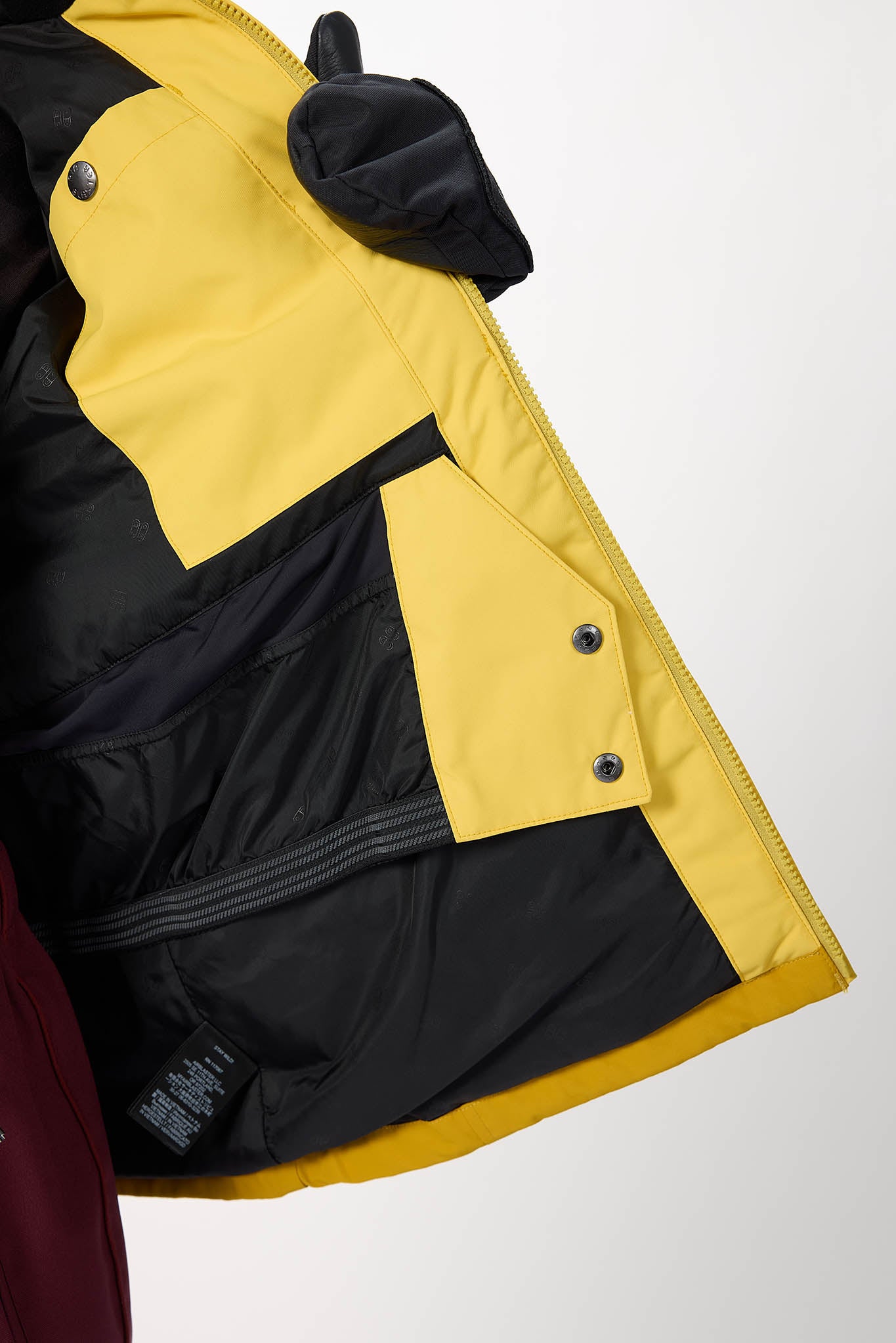 Close-up of a black and yellow jacket with a white background