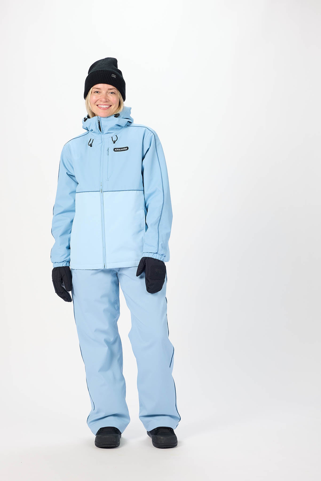 Person wearing a light blue snowsuit on a white background