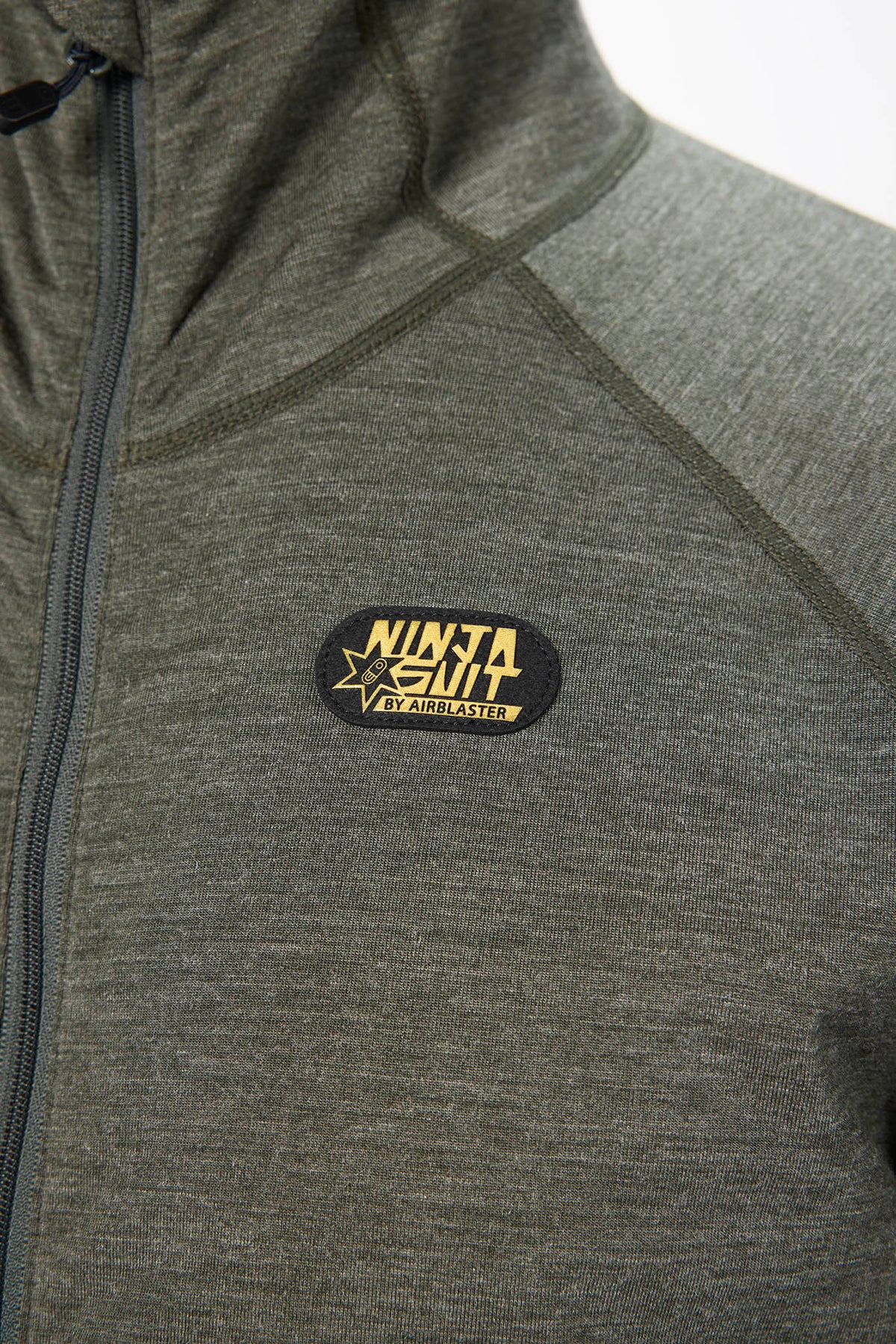 Close-up of a heather gray zip-up jacket with a black and yellow 'NINJA SUIT' patch on the chest.