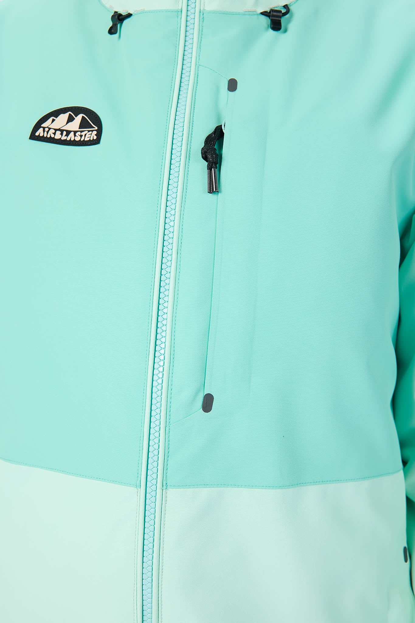 Close-up of a teal jacket with a brand logo on a white background