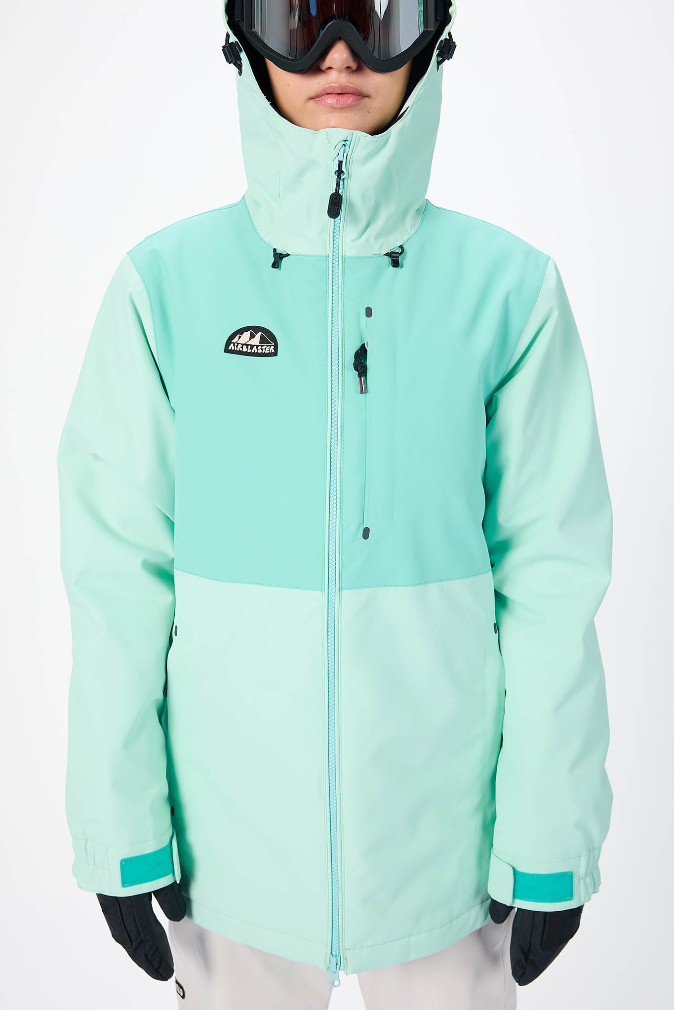 Person wearing a light blue snow jacket with a brand logo on a white background