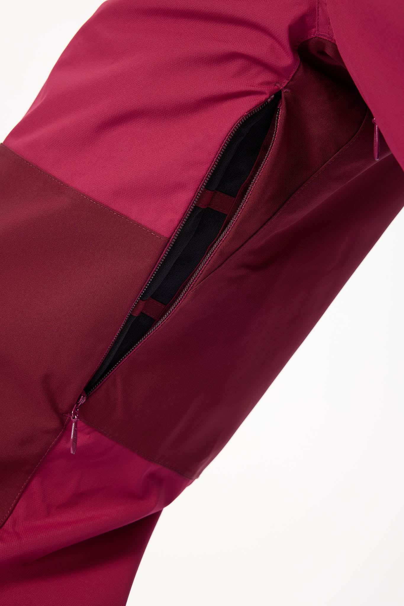 Close-up of a red jacket with a zipper on a white background