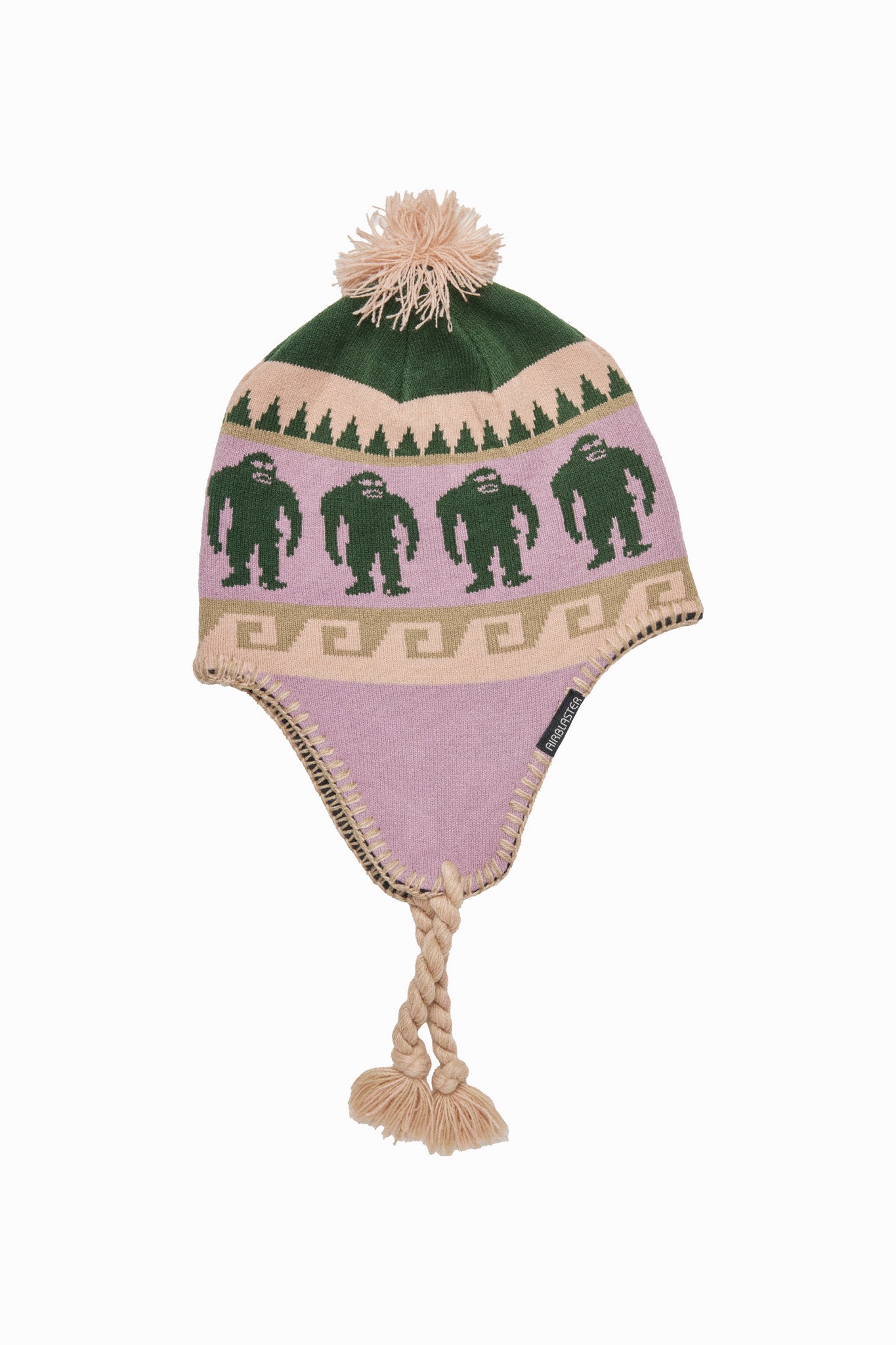 A knit winter hat with ear flaps, a pom-pom, and braided tassel ties, featuring a pink body with green Bigfoot figures and tree motifs, plus beige and green patterned bands.