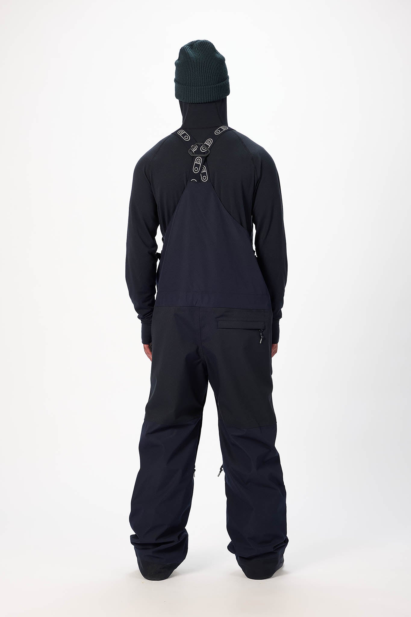 Person wearing a black snowsuit with a white background