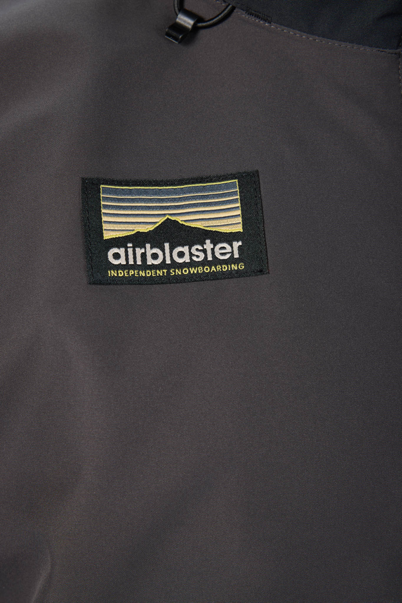 Airblaster logo on a dark gray jacket