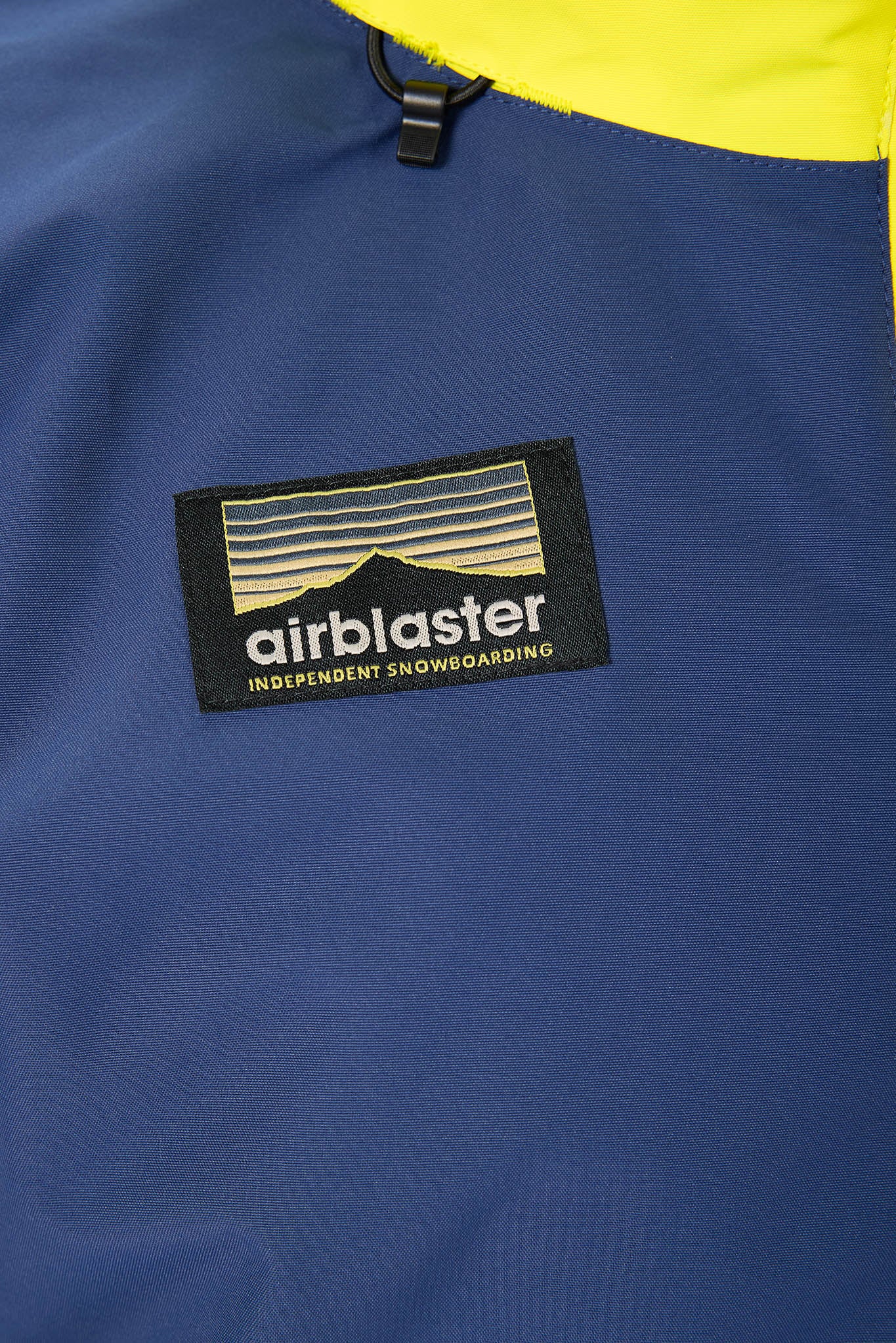 Airblaster logo on a blue jacket with yellow top
