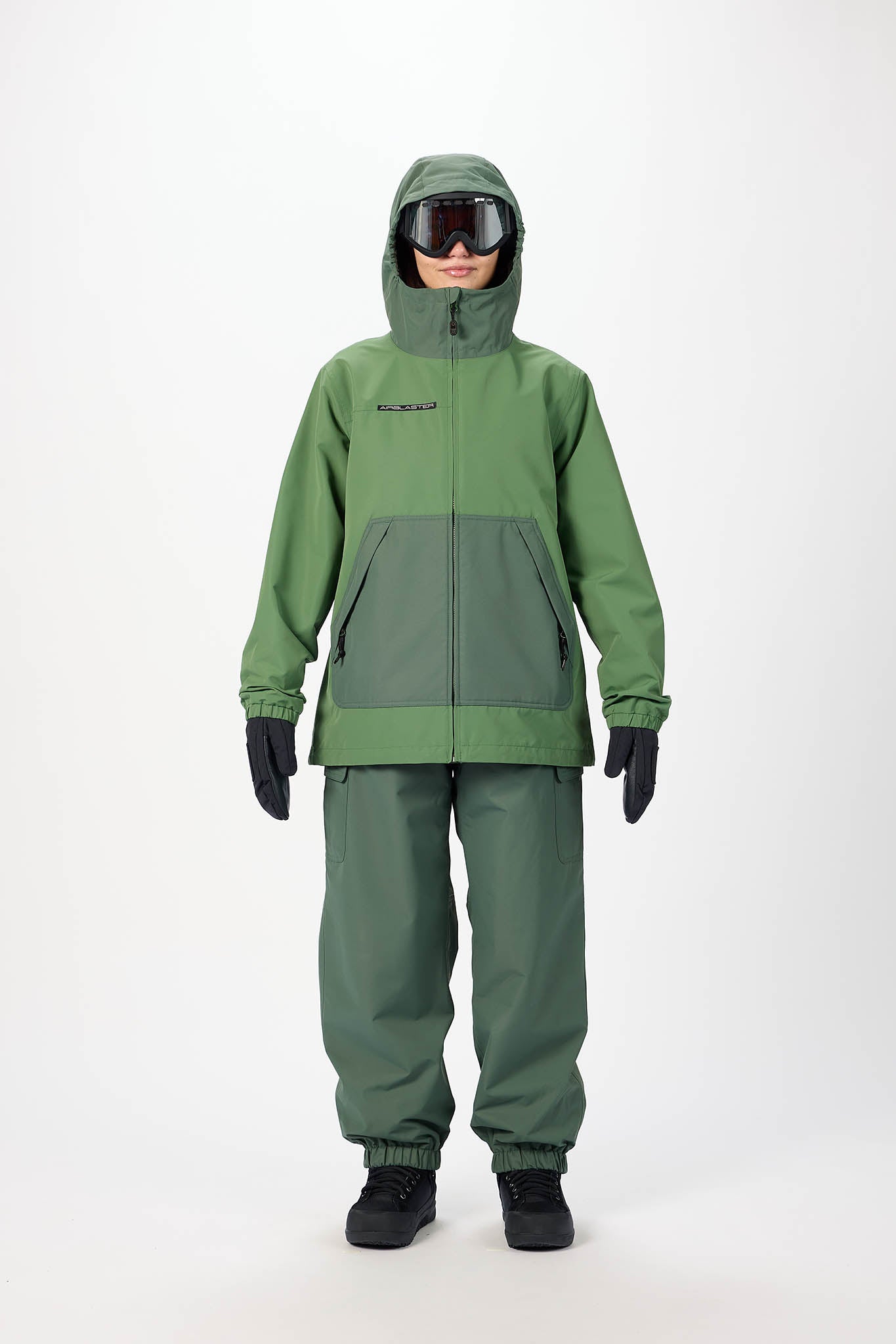 Person wearing a green raincoat and pants set on a white background
