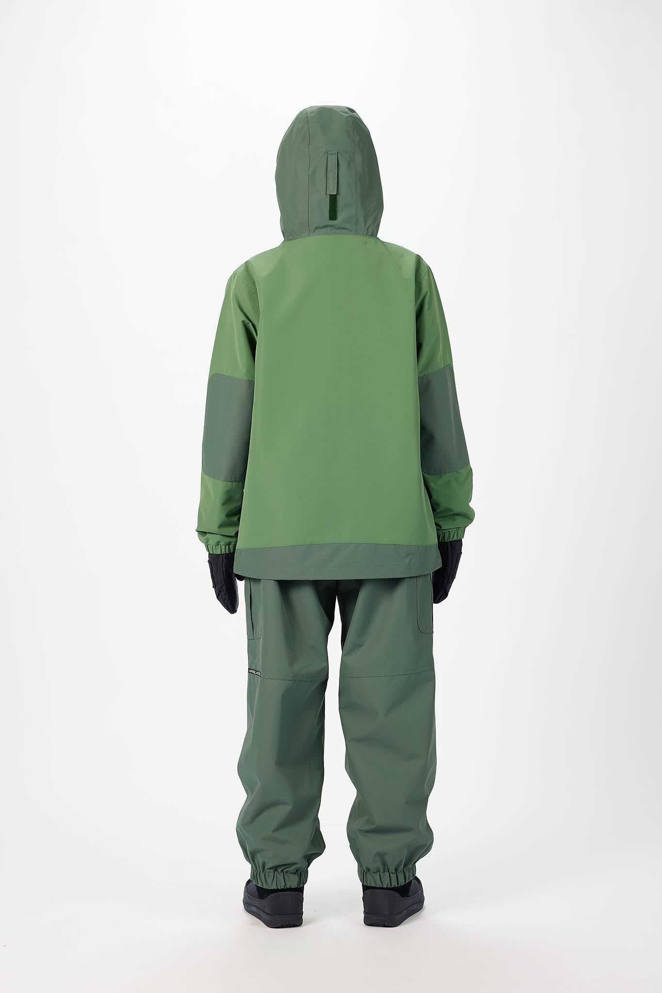 Green raincoat and pants set on a white background