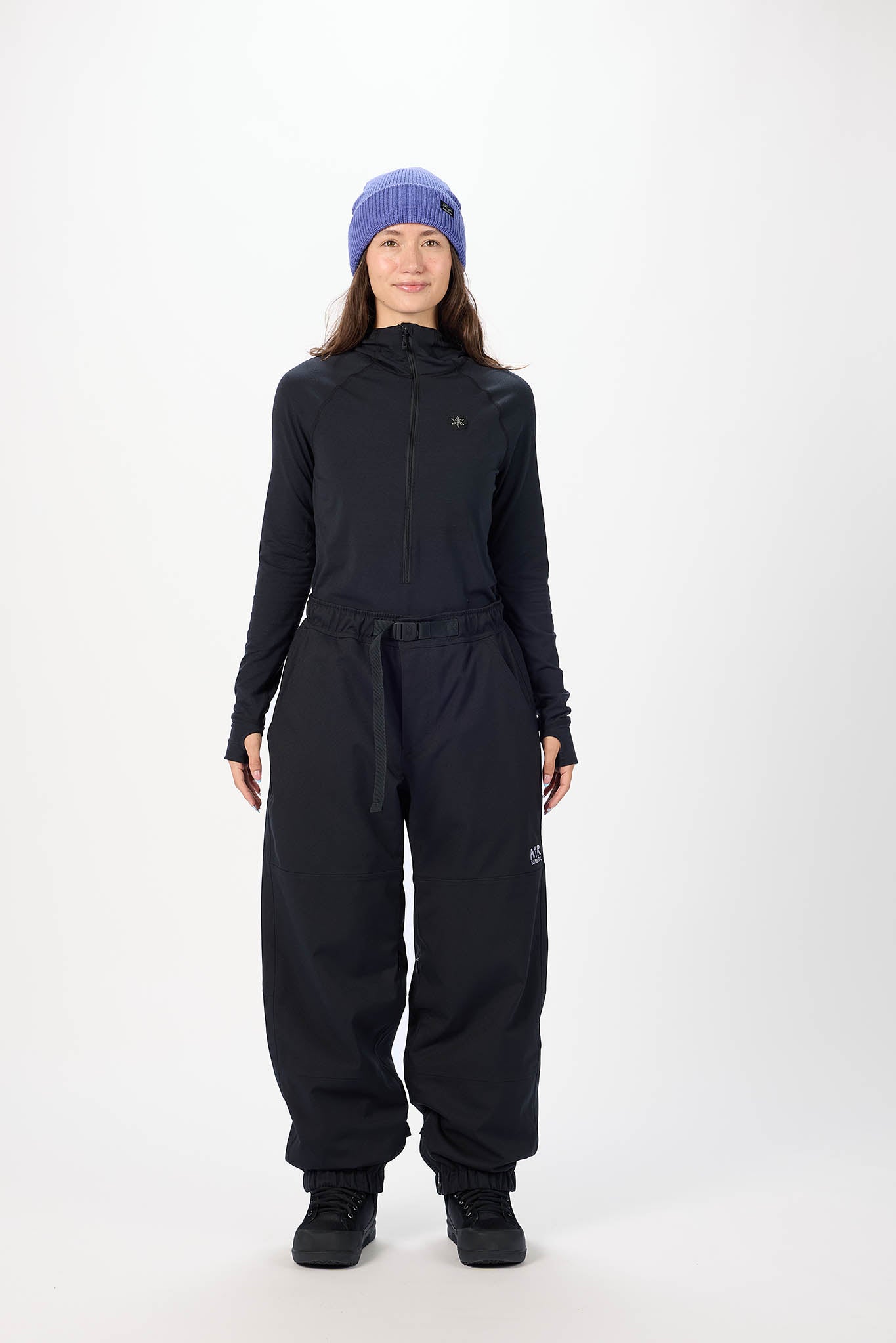 Person wearing a black outfit with a hood and pants on a white background