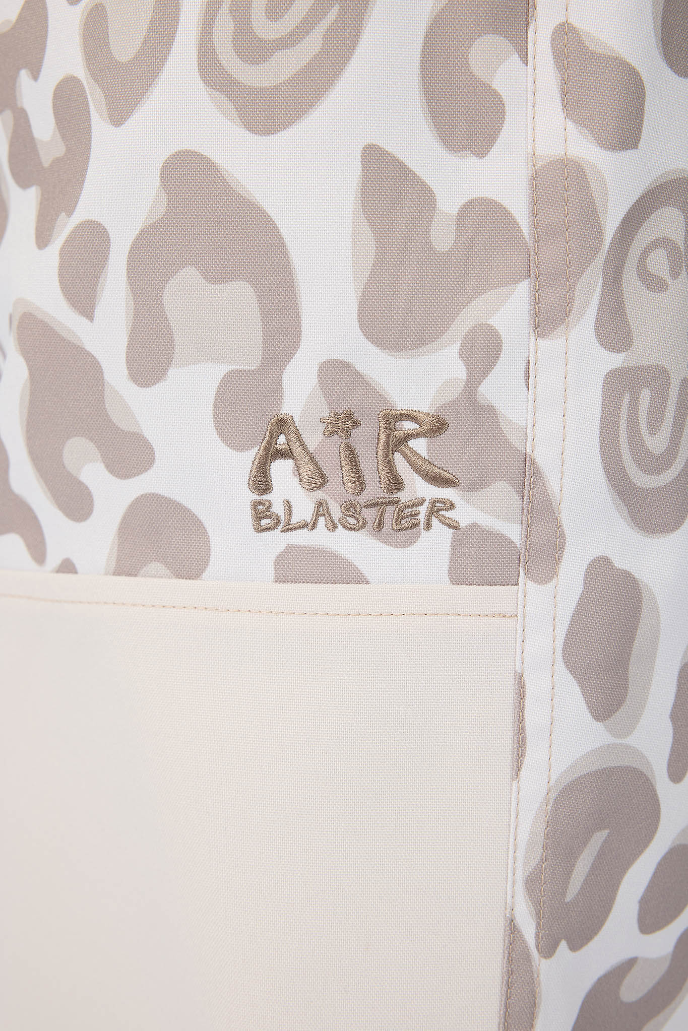 Leopard print bag with 'Air Blaster' logo on a beige background