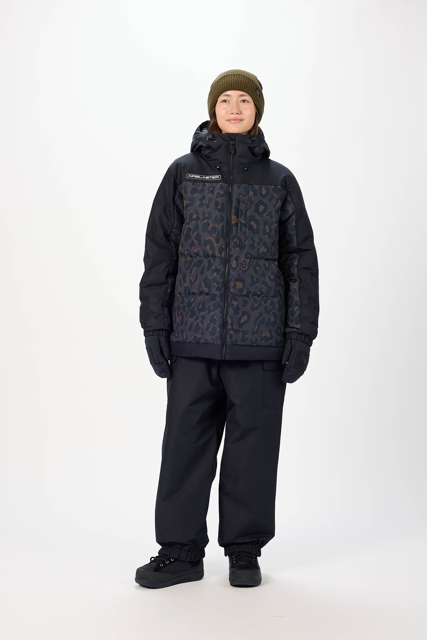 Person wearing a black patterned jacket and pants on a white background